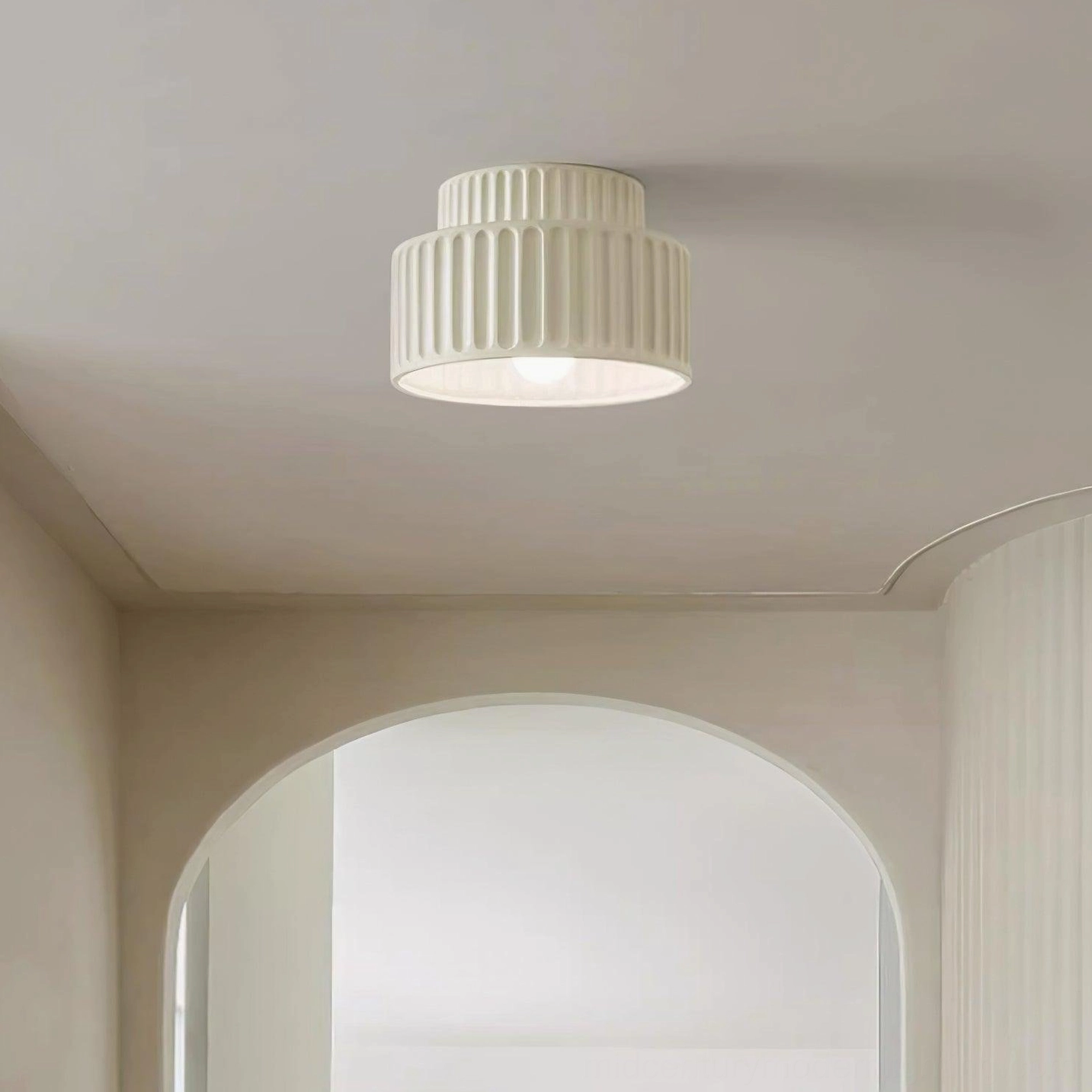 Kami ribbed resin ceiling lamp in industrial-modern space with exposed brick and metal accents