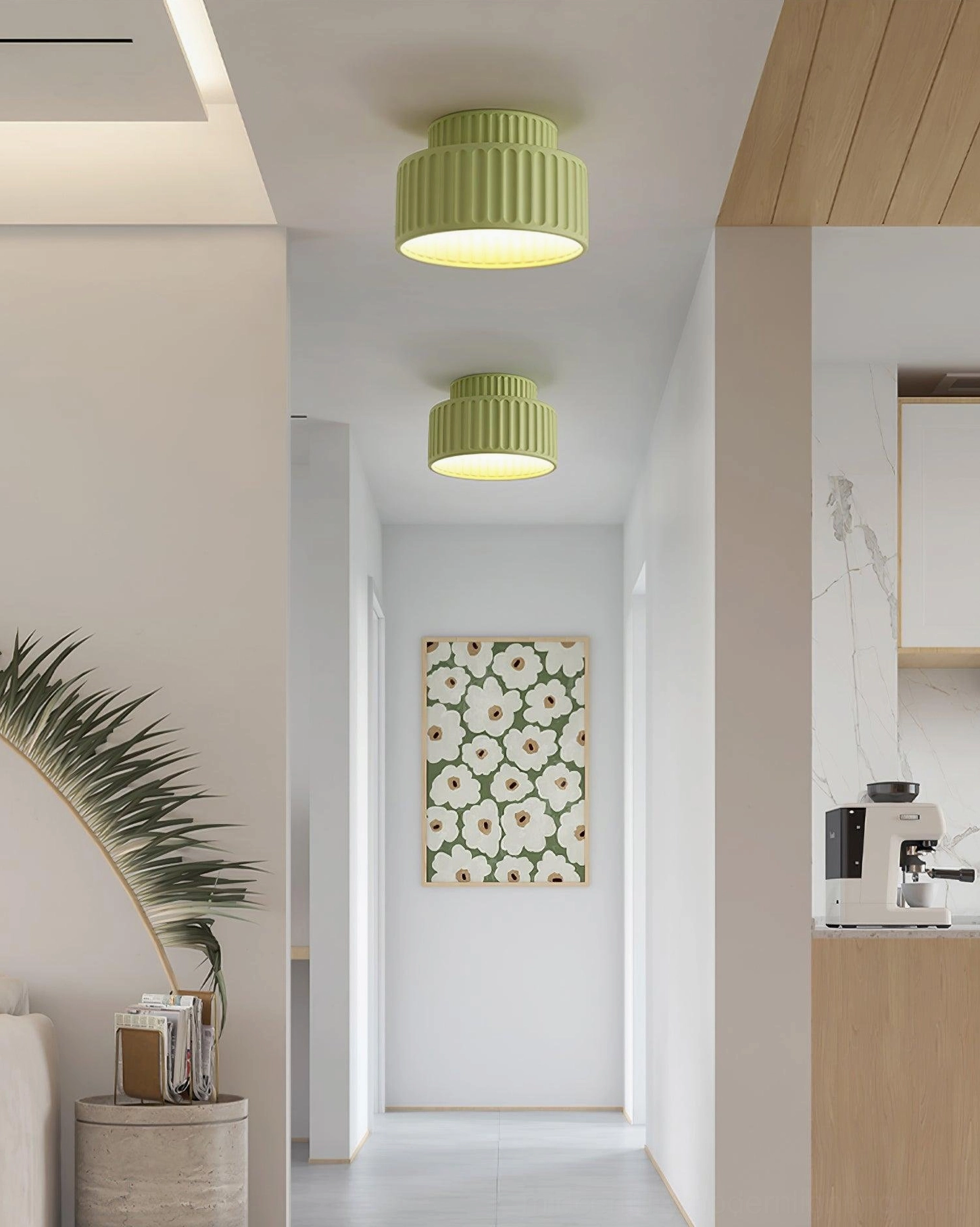 Two moss green Kami fluted ceiling lamps in open modern kitchen and hallway space with decorative wall art, matching green flush lights