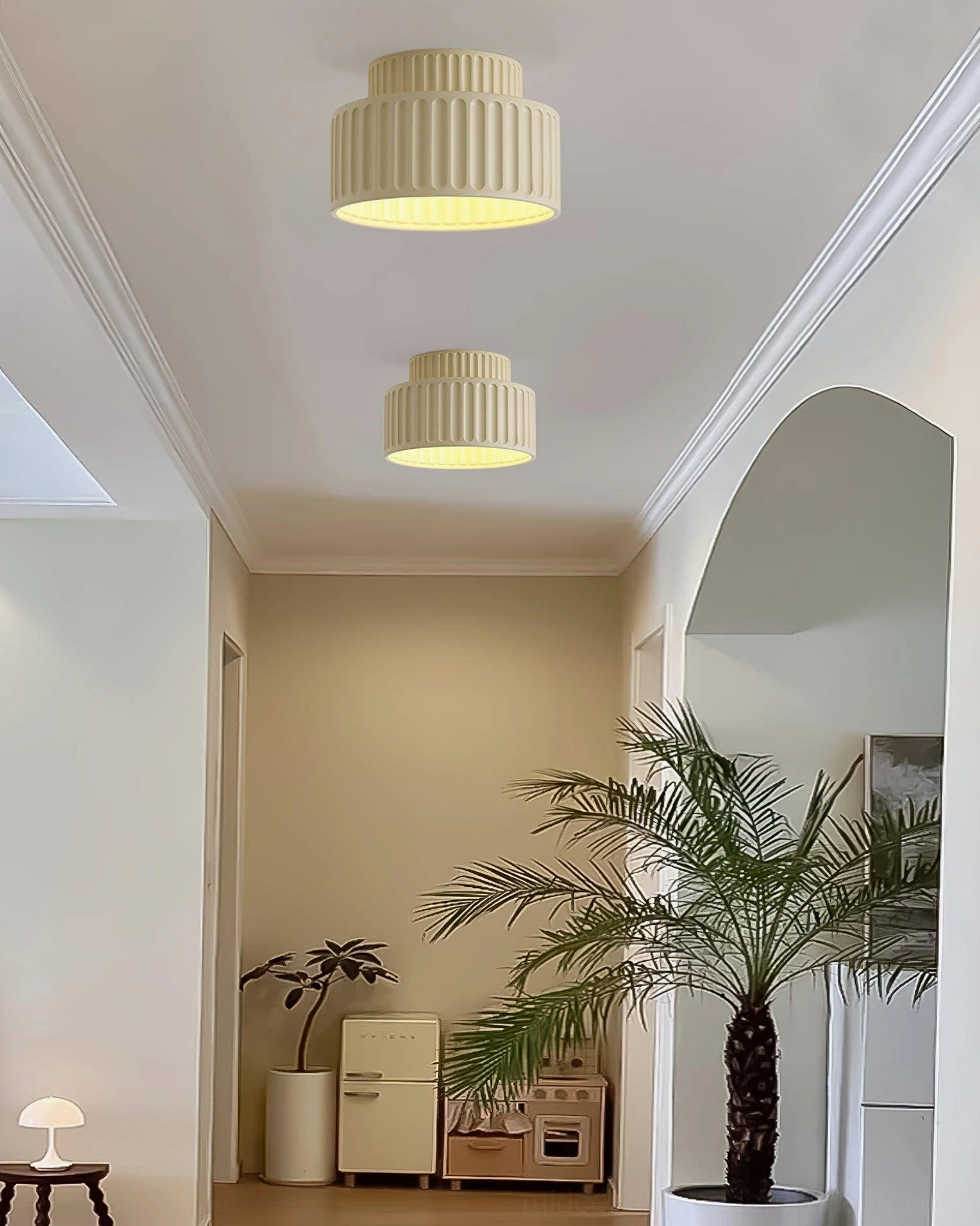 Two Kami ceiling lamps in different sizes installed in cozy residential hallway with plants and vintage furniture, warm dual lighting