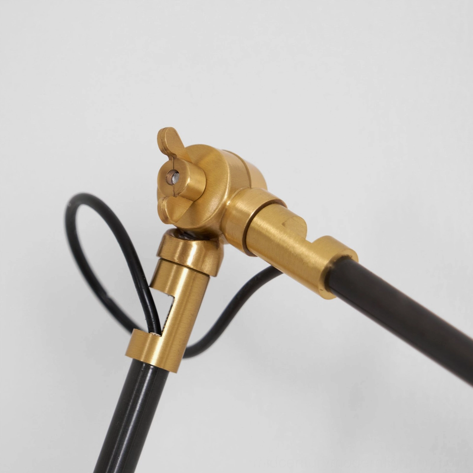 Kane Swing Arm Wall Lamp close-up of brass die-cast joint connector and arm detail
