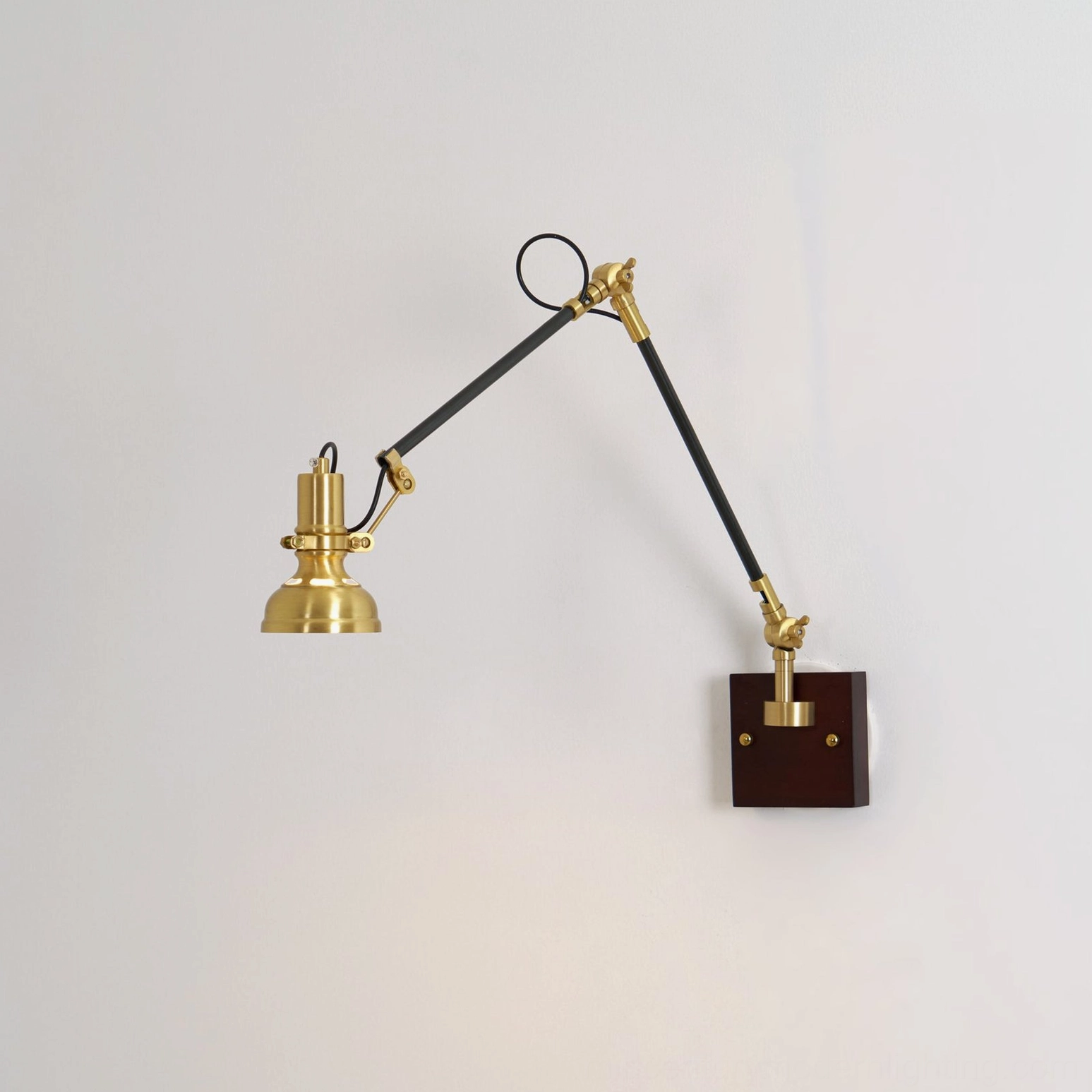 Kane Swing Arm Wall Lamp die-cast brass construction and walnut mounting plate detail