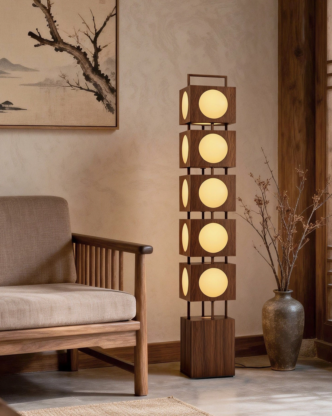 Kano Totem Floor Lamp beside wooden armchair, side angle shot with dried floral vase and oriental wall art, intimate lighting