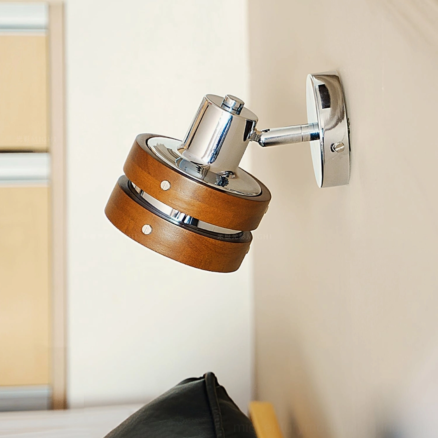 Karry wall sconce showing polished chrome and walnut wood construction detail