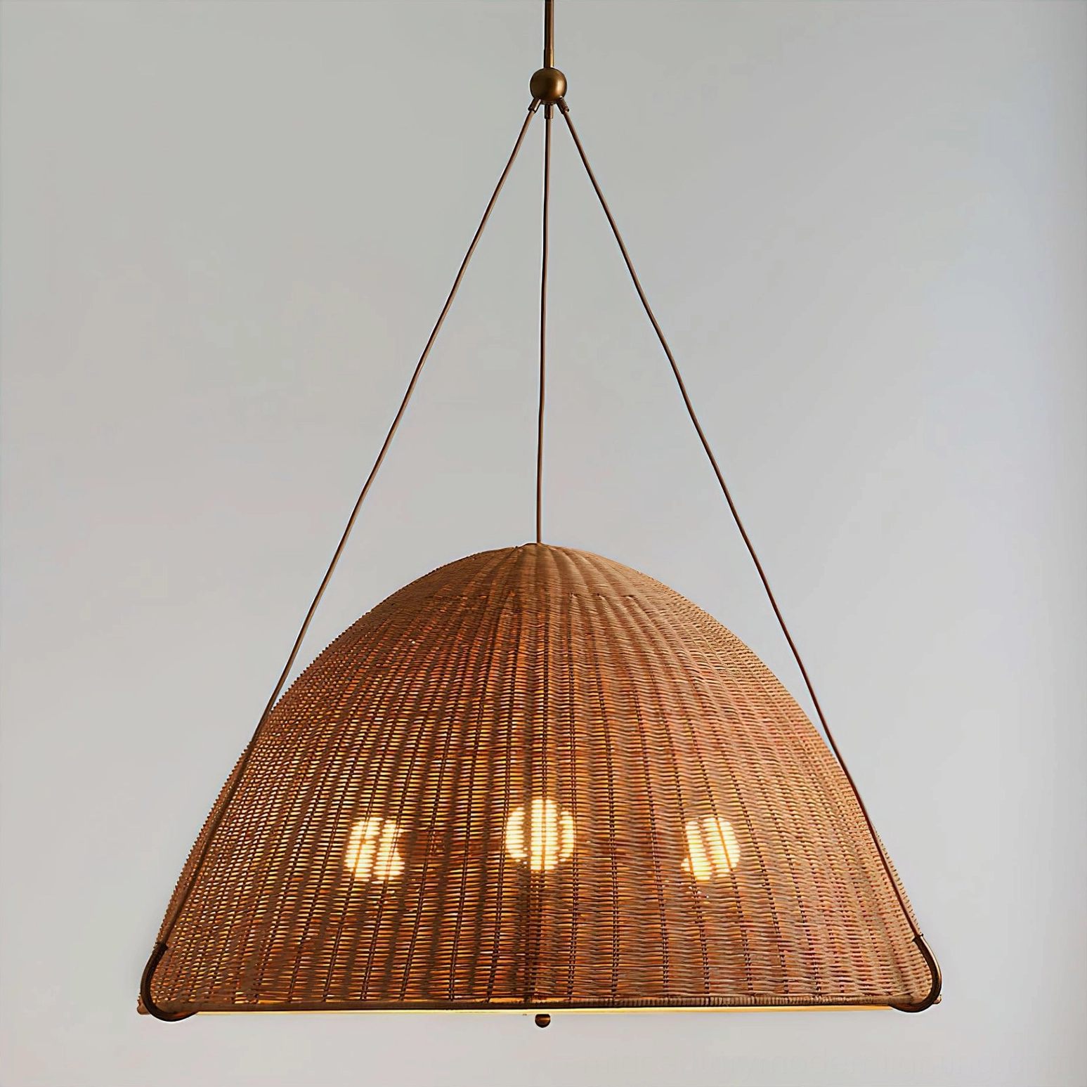 Kash woven rattan pendant light casting soft diffused glow in residential interior design