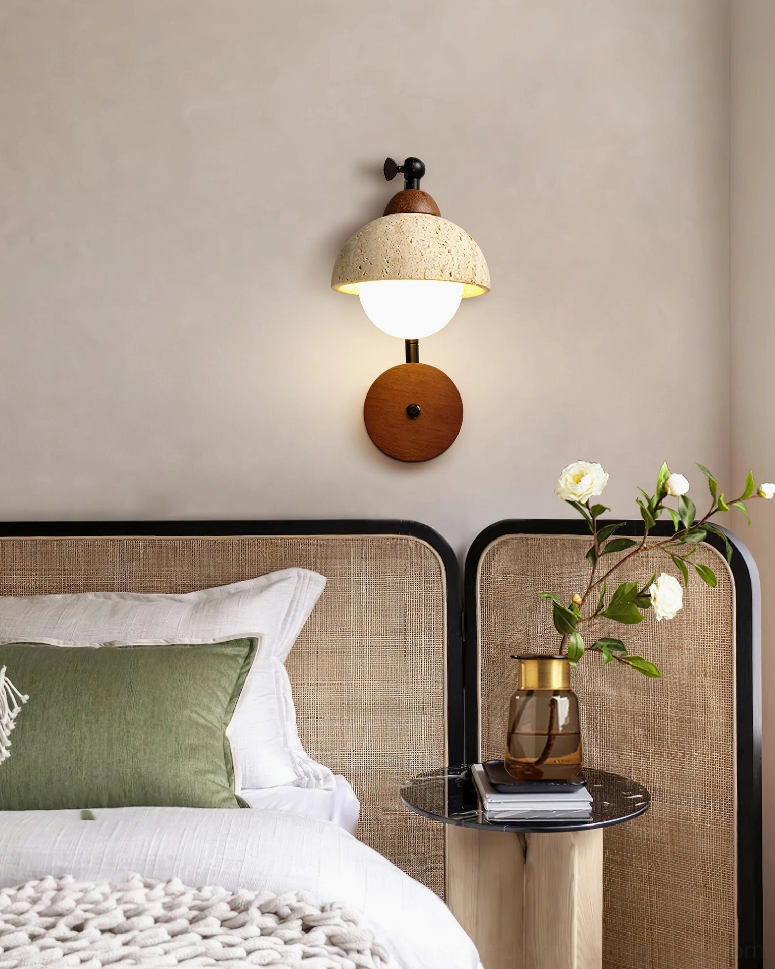 Kell travertine wall light mounted above bedroom bedside table, compact cozy bedroom accent lighting