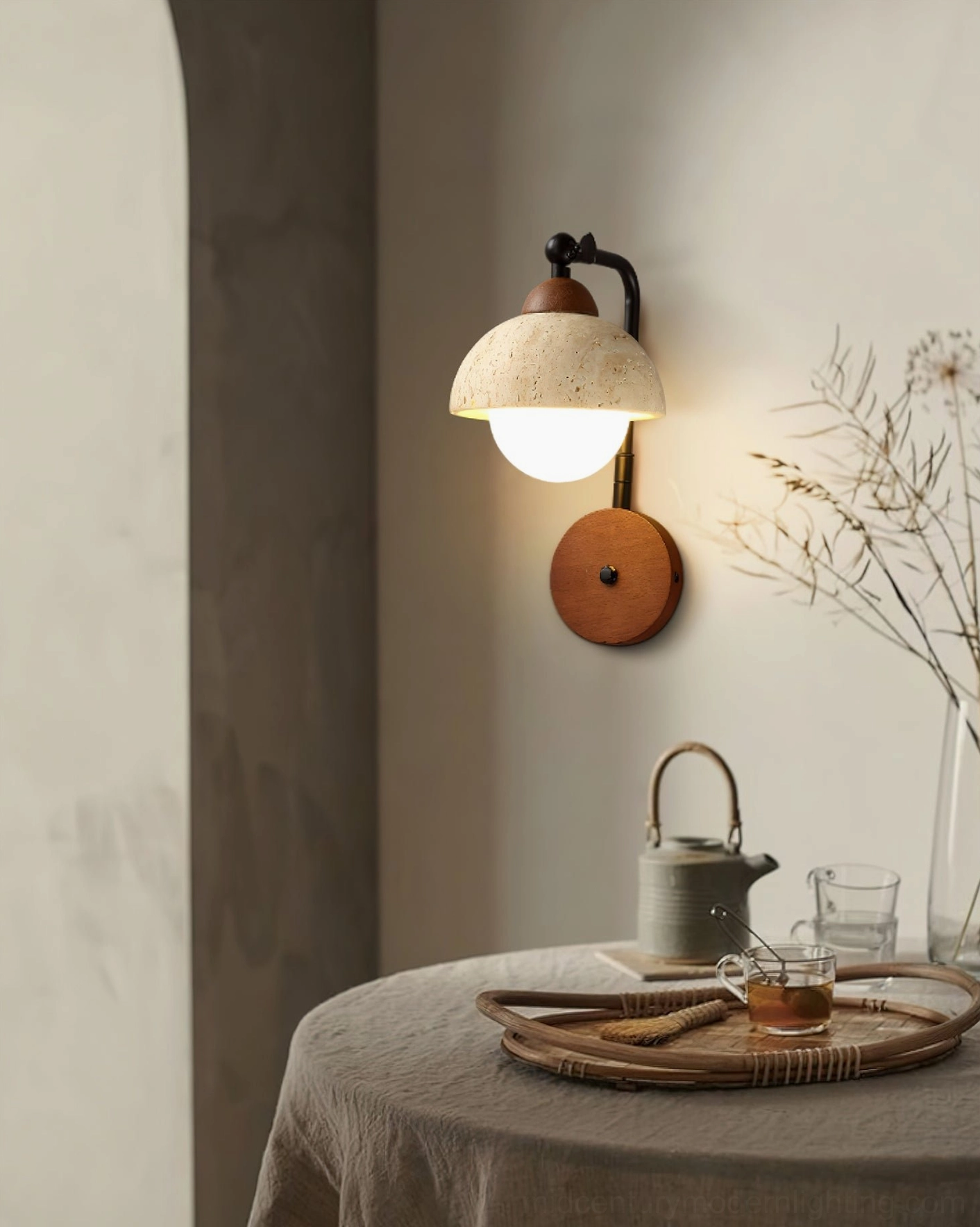Kell travertine wall lamp over dining table nook with dried floral and tea set, ambient dining room lighting