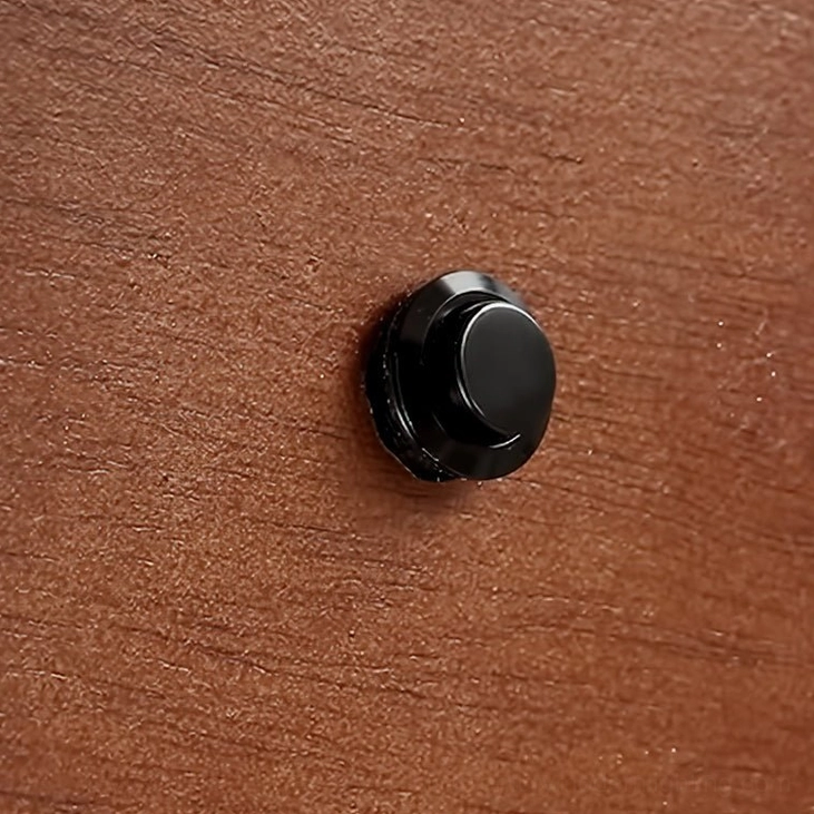 Kell wall lamp wooden base detail, natural walnut wood grain texture with black fixing hardware