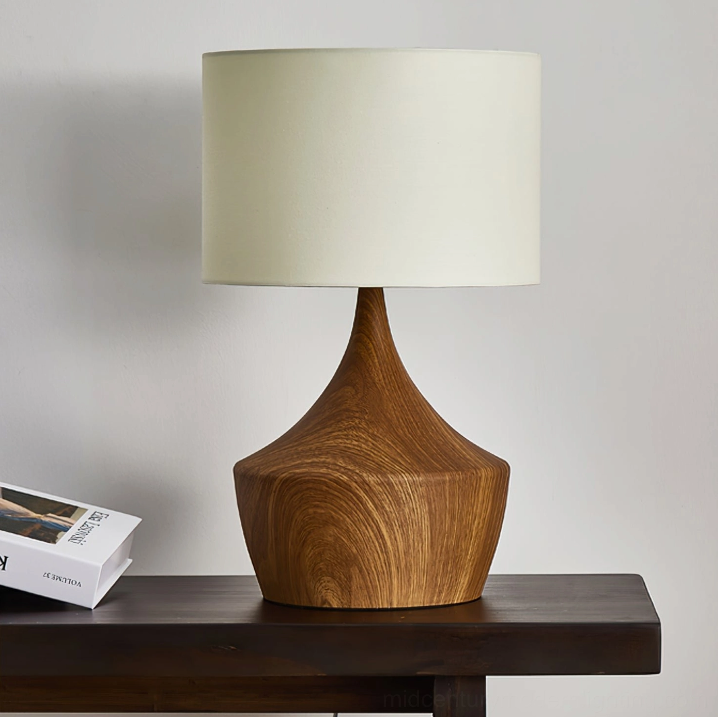 Kendra table lamp side view showing off-white fabric drum shade and wooden base detail
