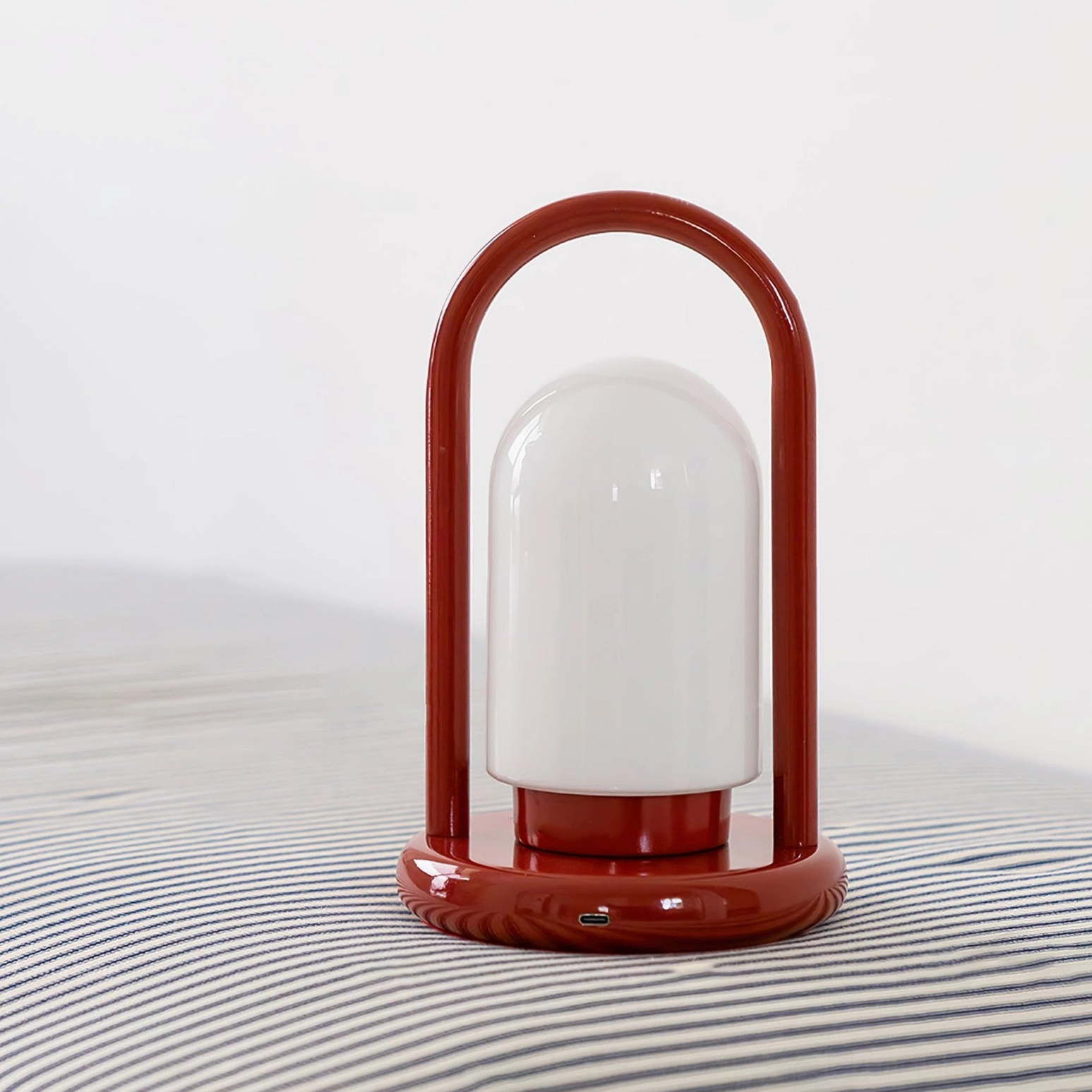 Kero portable LED table lamp compact size front view on gray fabric background