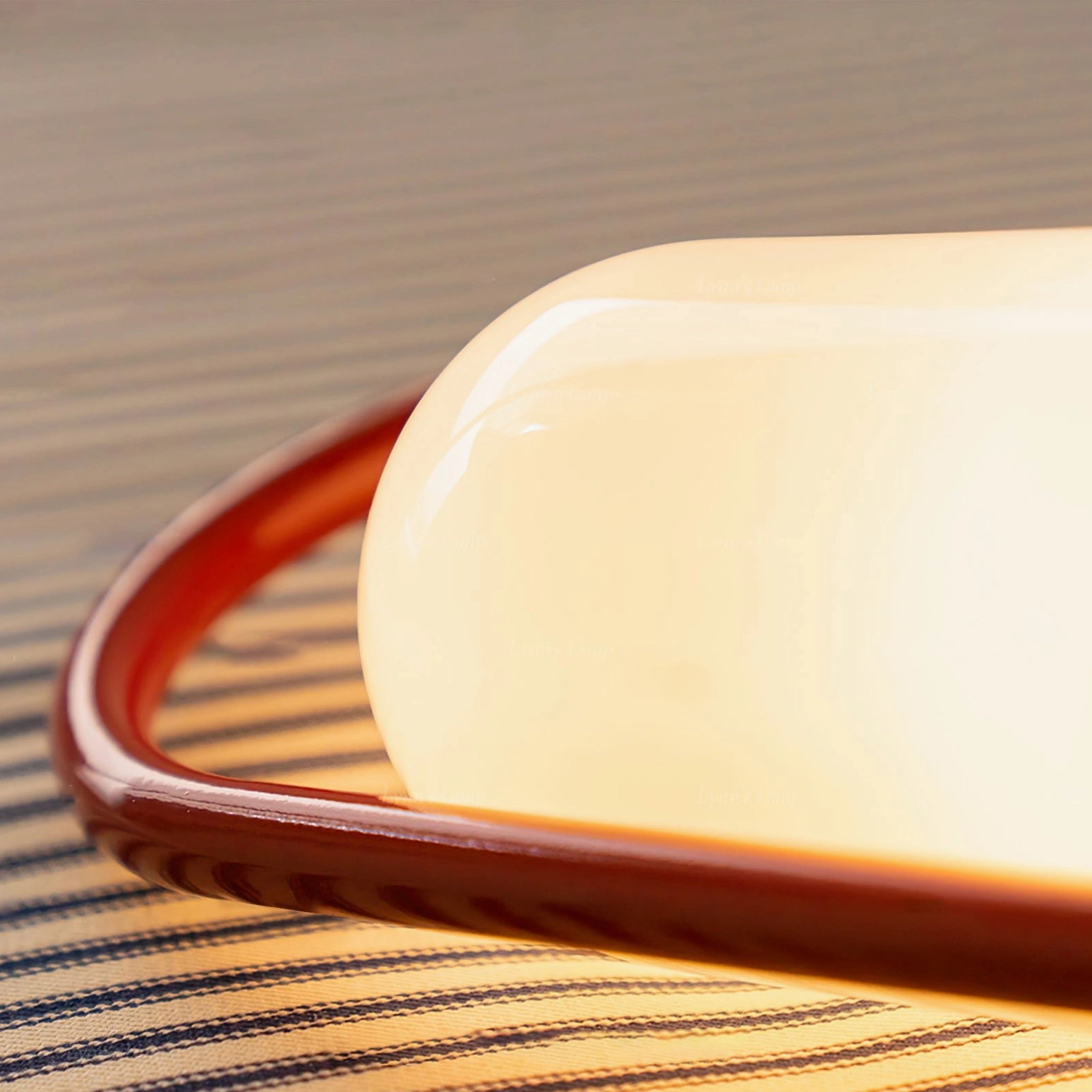 Kero portable lamp detail showing curved arched handle and illuminated frosted glass shade