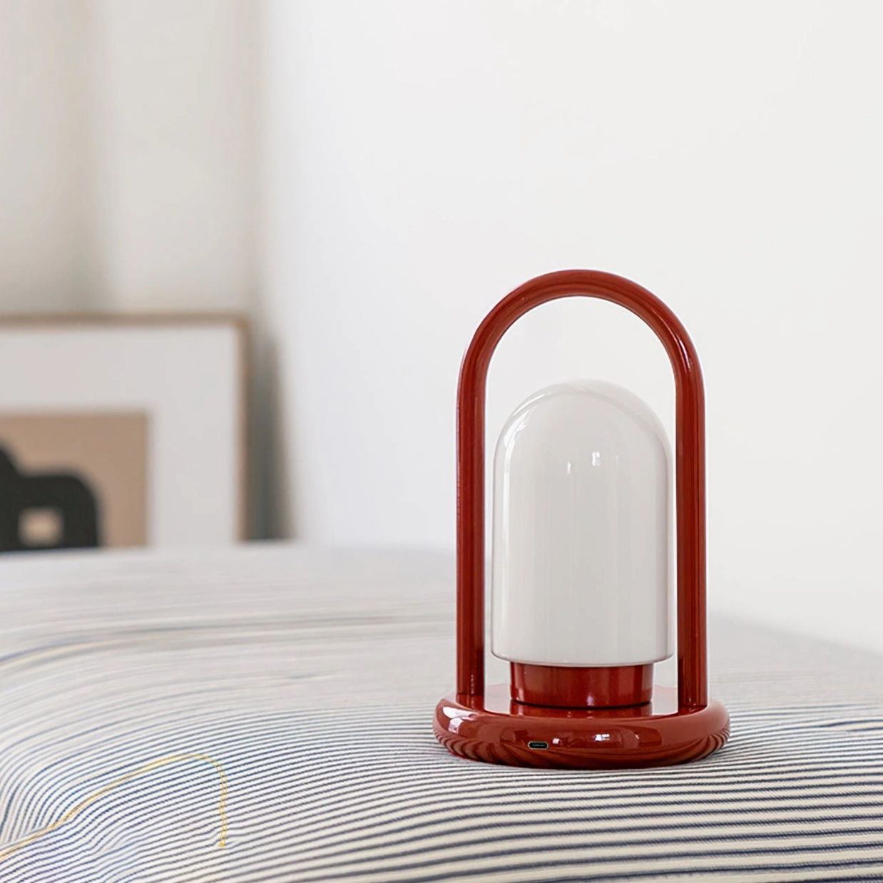 Kero cordless lamp on bedroom surface with wall art decor, minimalist mid-century modern style