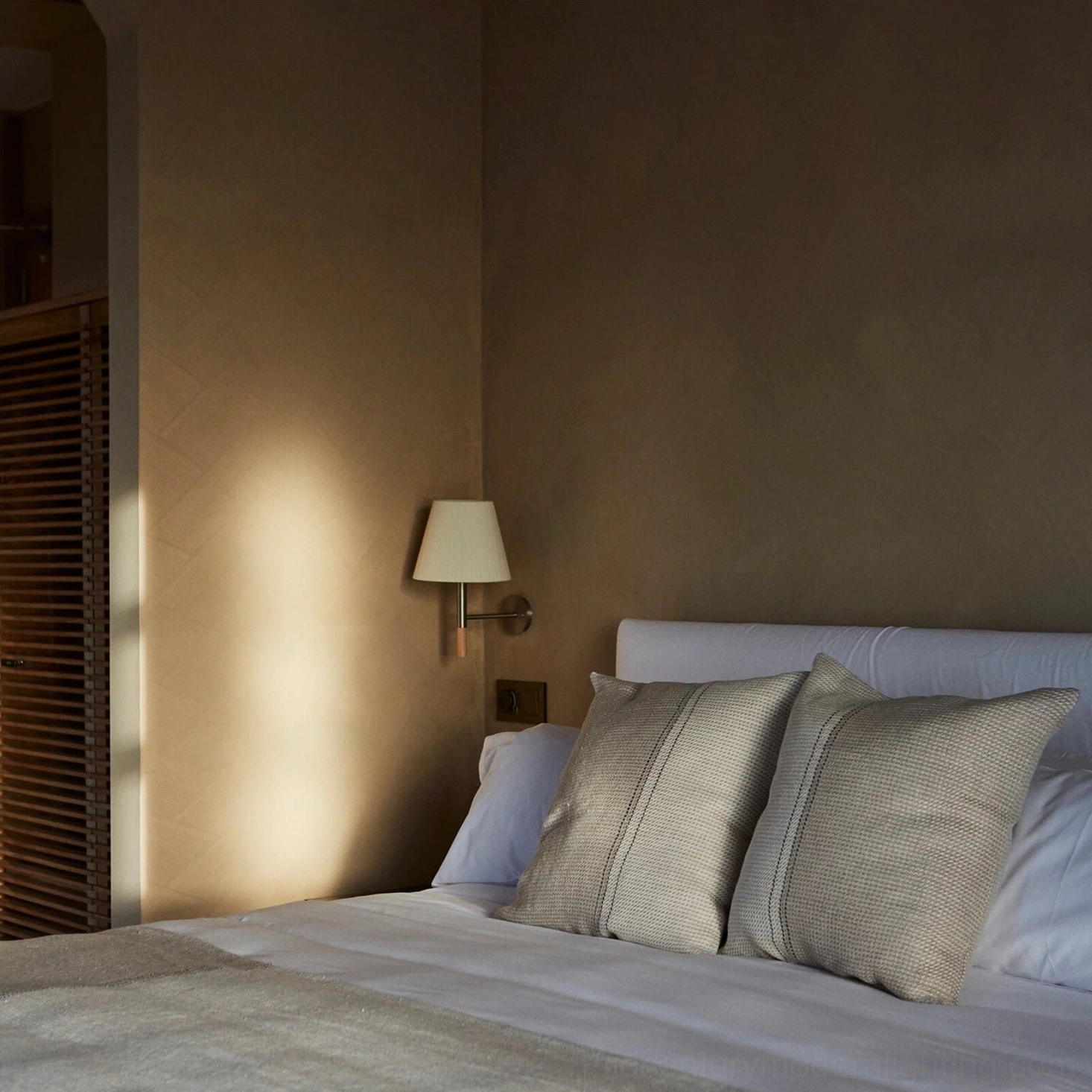 Kilkee modern wall lamp in minimalist bedroom with soft ambient lighting accent