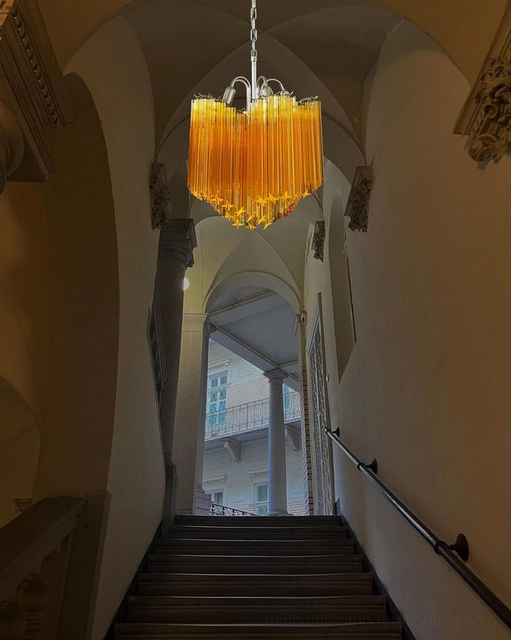 Kite amber chandelier in historic arched stairwell vintage corridor lighting