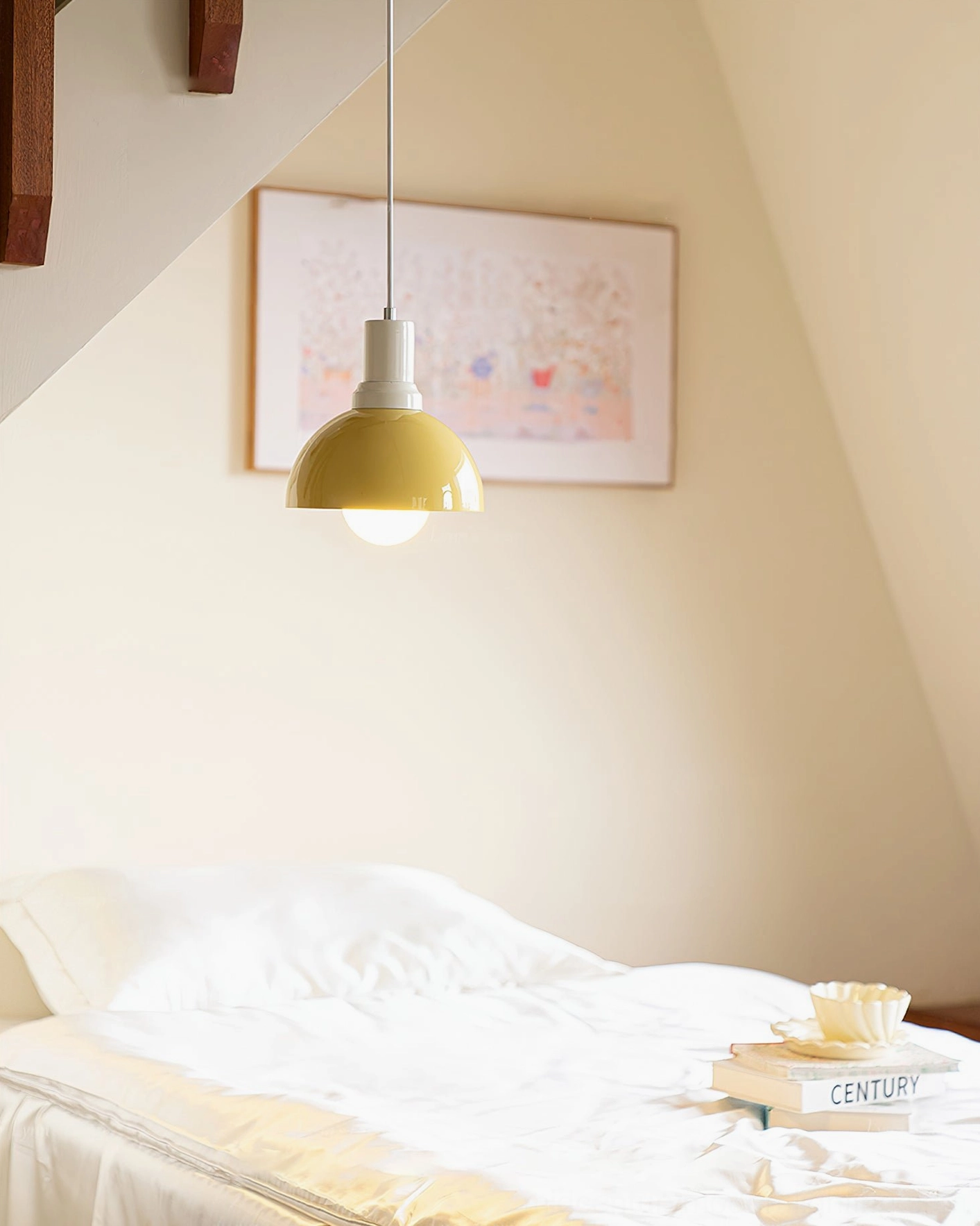 Kleine yellow pendant light over bedside table – contemporary attic bedroom with books and minimalist decor