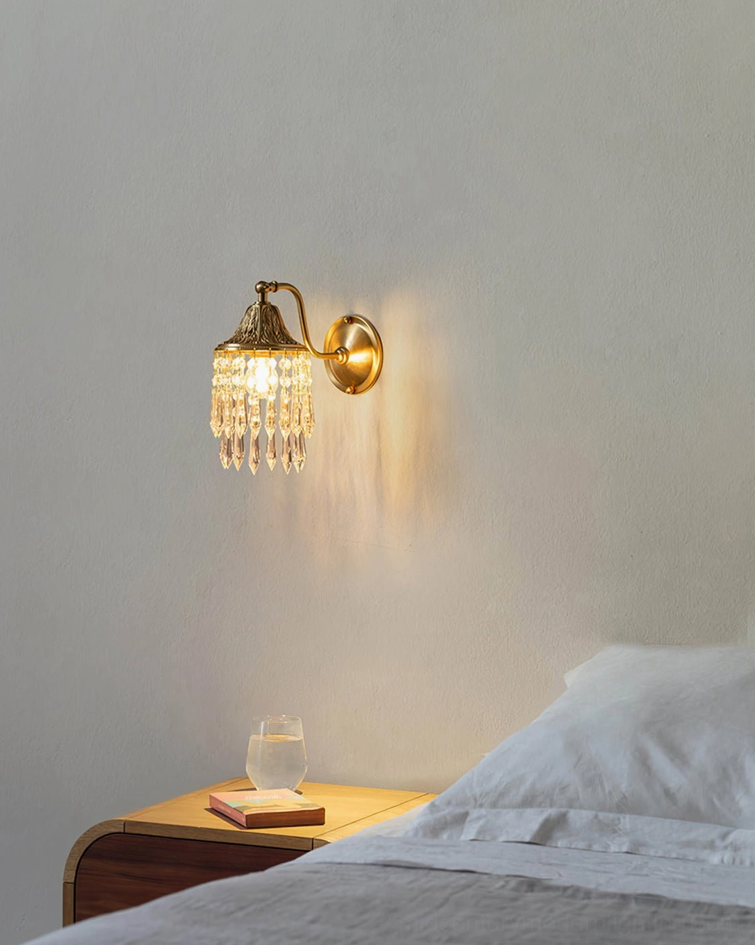 Kristall crystal wall lamp in master bedroom setting by bedside table with warm retro luxury aesthetic