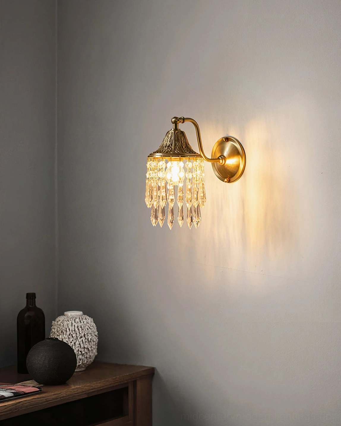 Kristall wall lamp in modern living room displaying elegant brass fixture complementing contemporary interior design