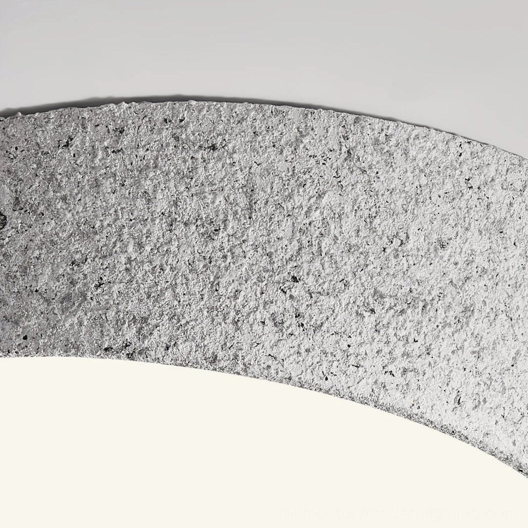 Close-up detail of Kuzco light gray textured metal frame surface