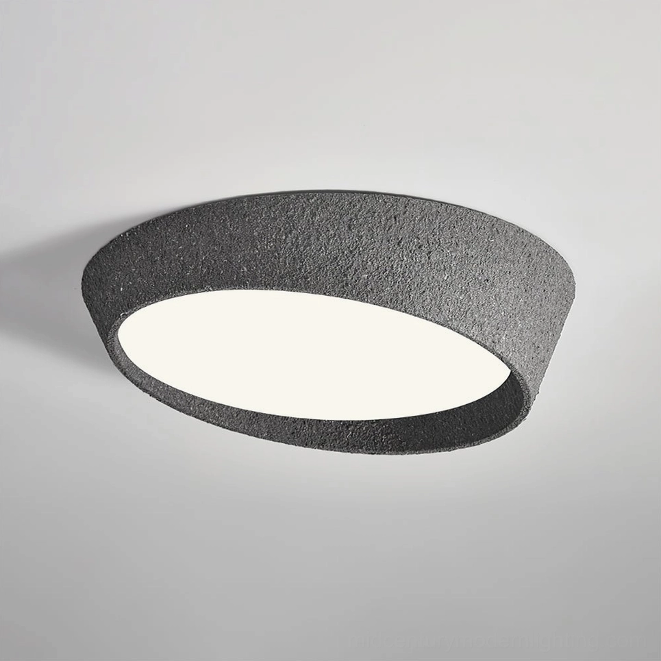 Kuzco textured ceiling light mounted indoors with warm white LED glow