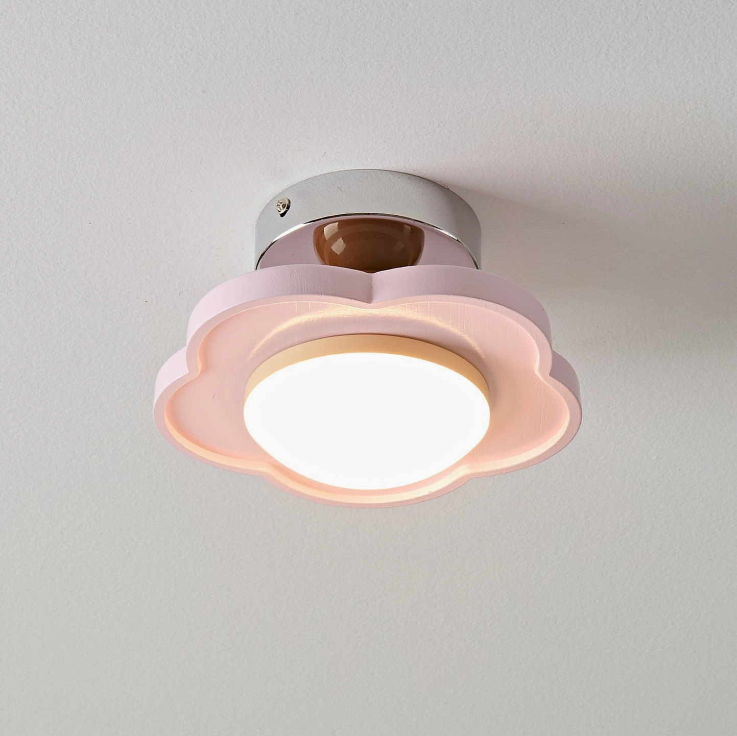 Laguna pink flush mount ceiling lamp illuminated, warm cozy light diffusion, pastel minimalist aesthetic