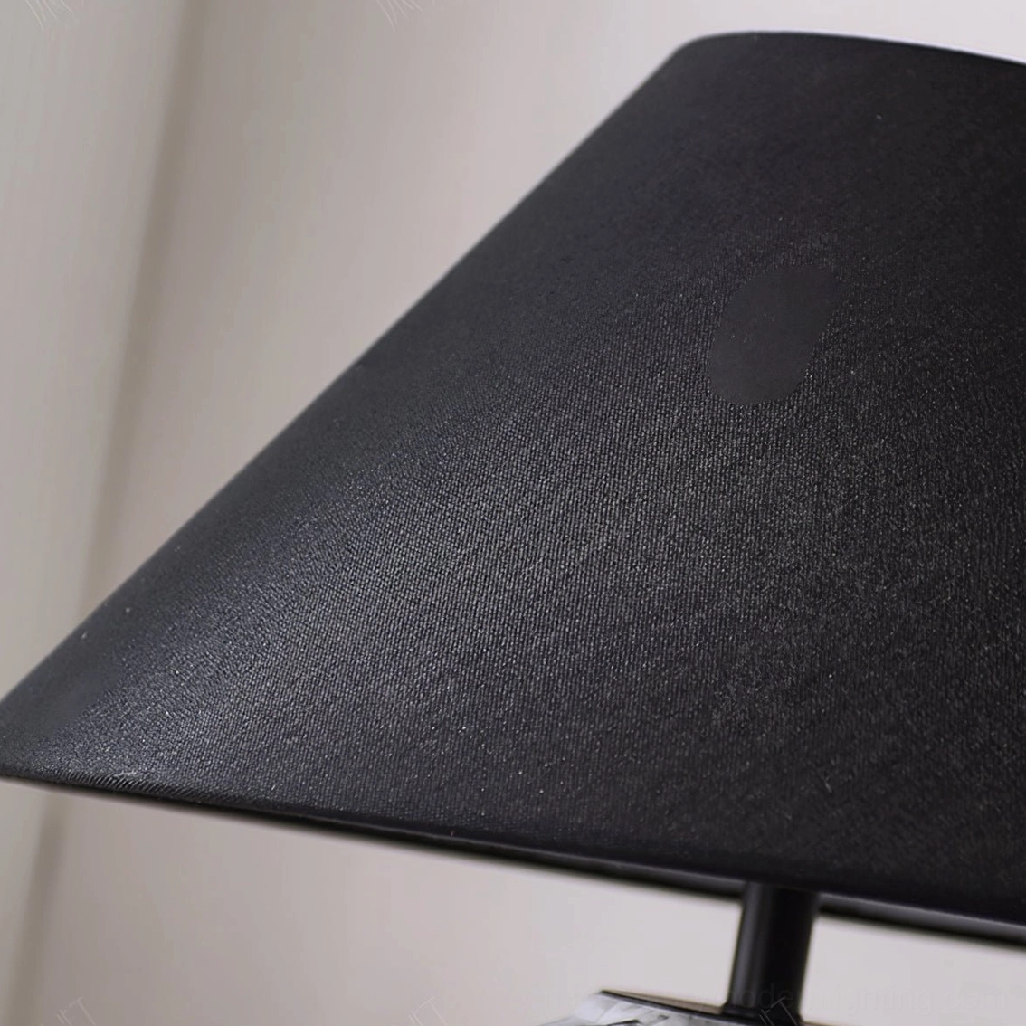 Close-up detail of black linen lamp shade and metal fixture structure