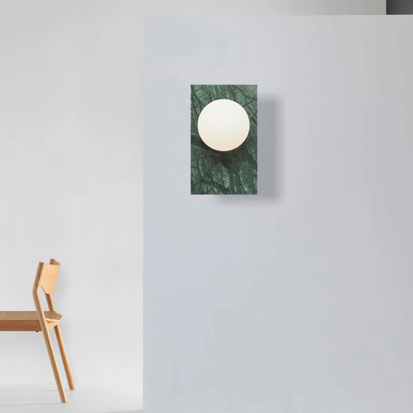 Frontal product photography of Lan marble wall sconce against neutral background highlighting finish options