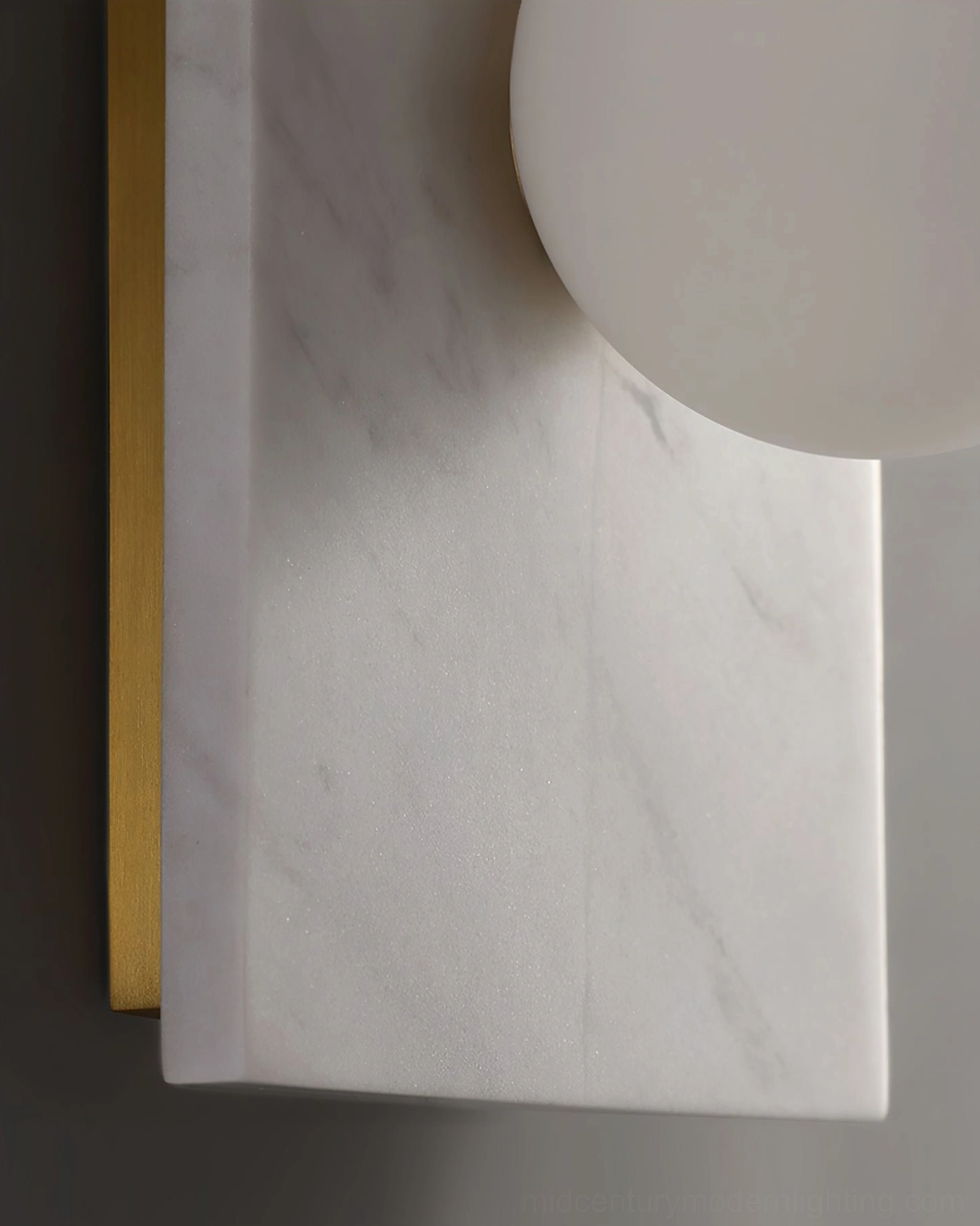 Side angle view of Lan wall lamp revealing depth and three-dimensional sculptural marble form