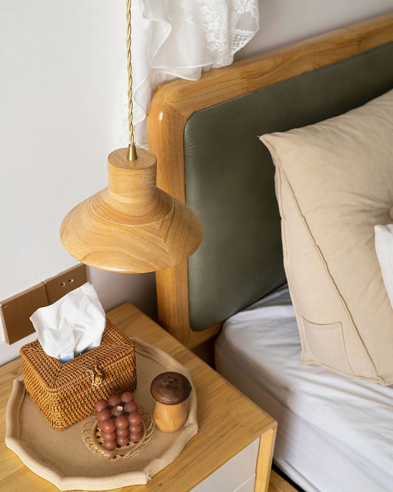 Lander wood pendant light in bedroom corner with wicker tissue box and wooden bed headboard