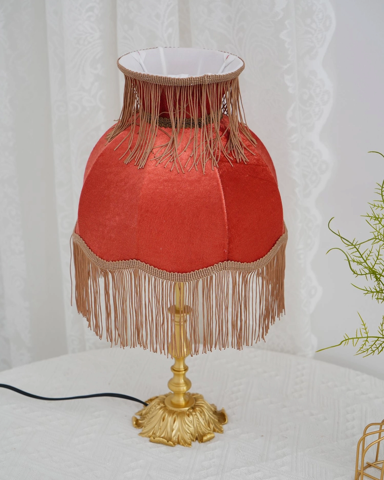 Lanna tassel table lamp detail view red fabric shade with sewn tassel trim golden brass base