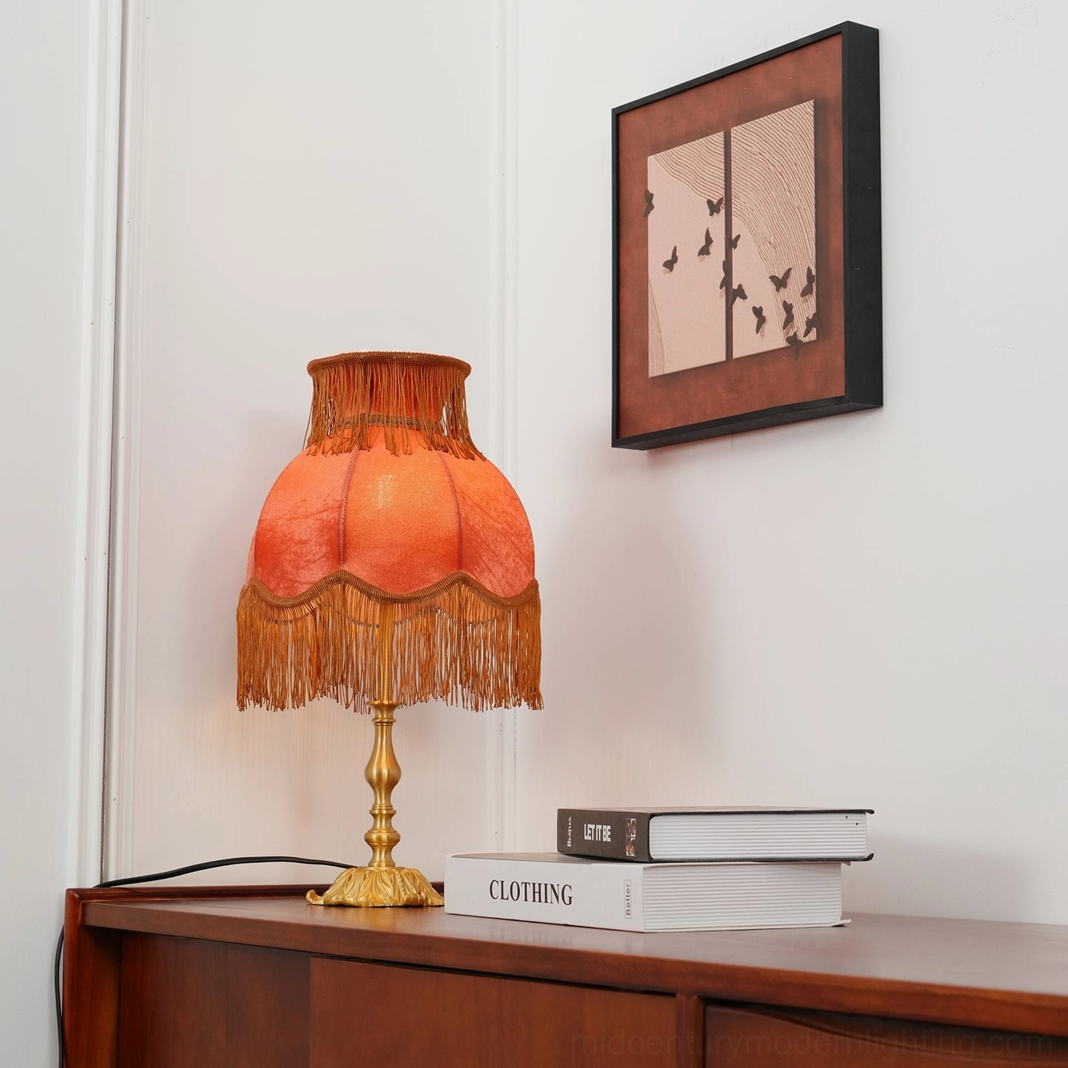 Lanna tassel lamp scalloped shade trim hand-sewn tassels wooden side cabinet stacked books wall art