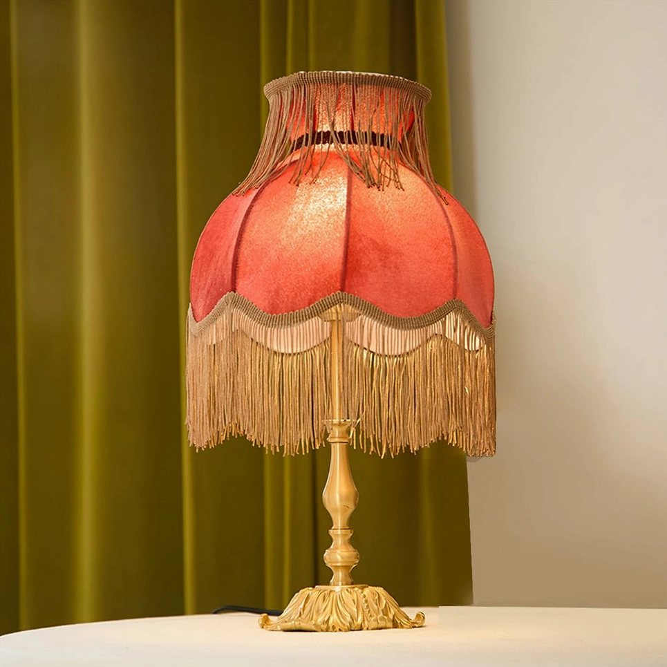 Lanna tassel lamp three-quarter view brass base red fabric shade tassels design detail