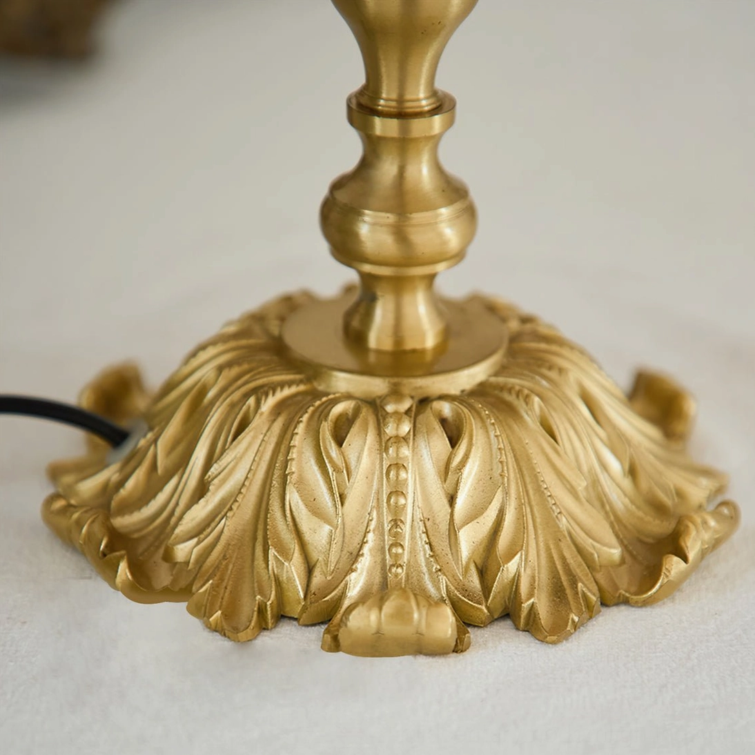 Lanna tassel table lamp burgundy fabric shade with tassels polished brass base studio photography