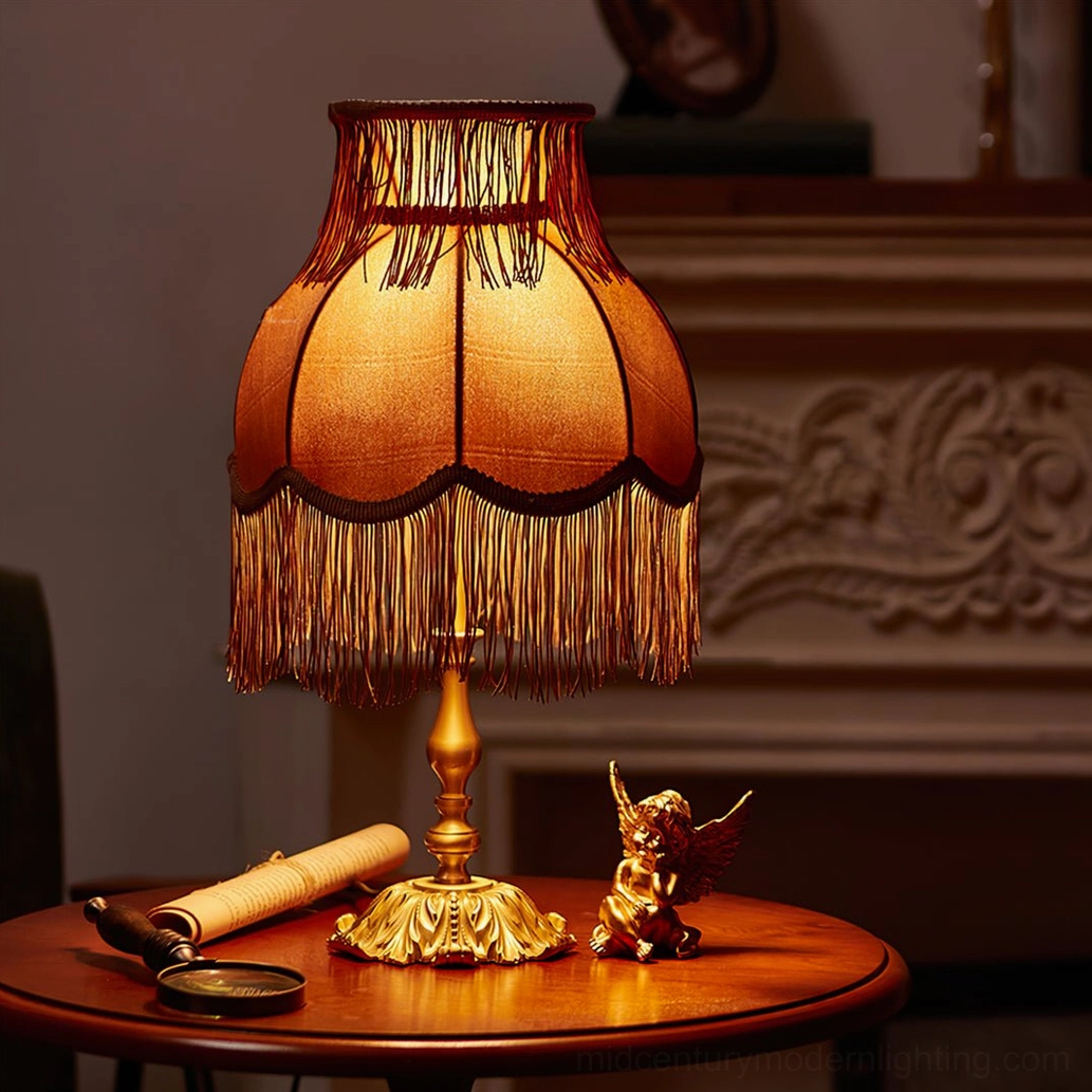Lanna tassel table lamp full product view burgundy red shade brass stem base white background