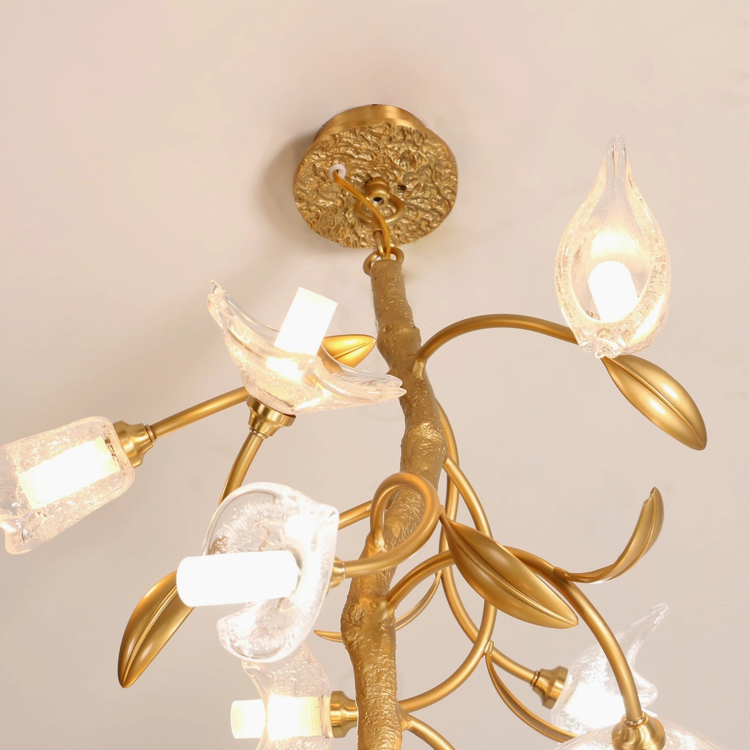 Large botanical branch chandelier in eclectic interior design space with artistic home decor elements