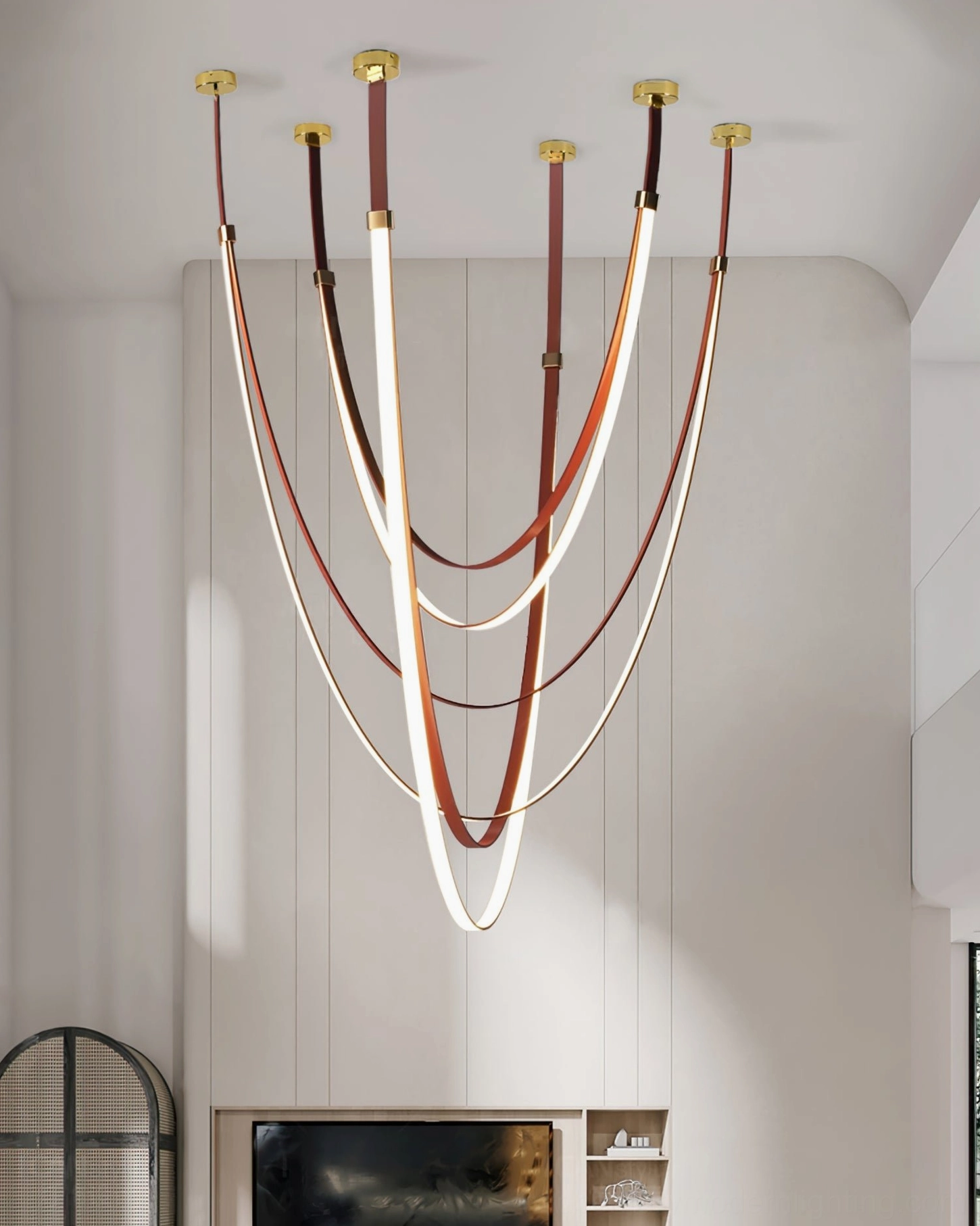 Large contemporary pendant light with layered curved leather straps, gold ceiling fixtures creating warm ambient lighting in living room