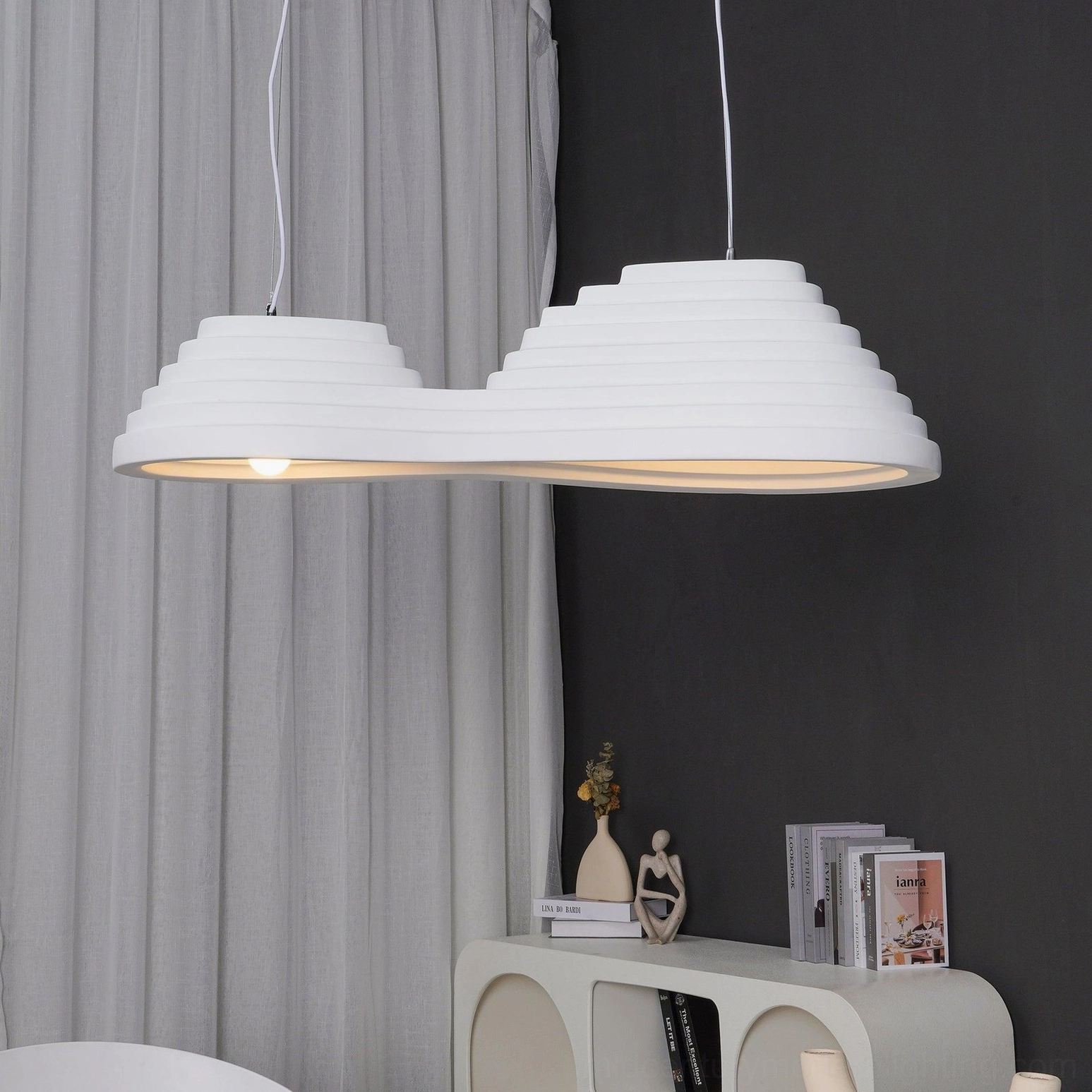 Large tiered pendant light fixture installed in spacious room showing dramatic scale and ambient illumination