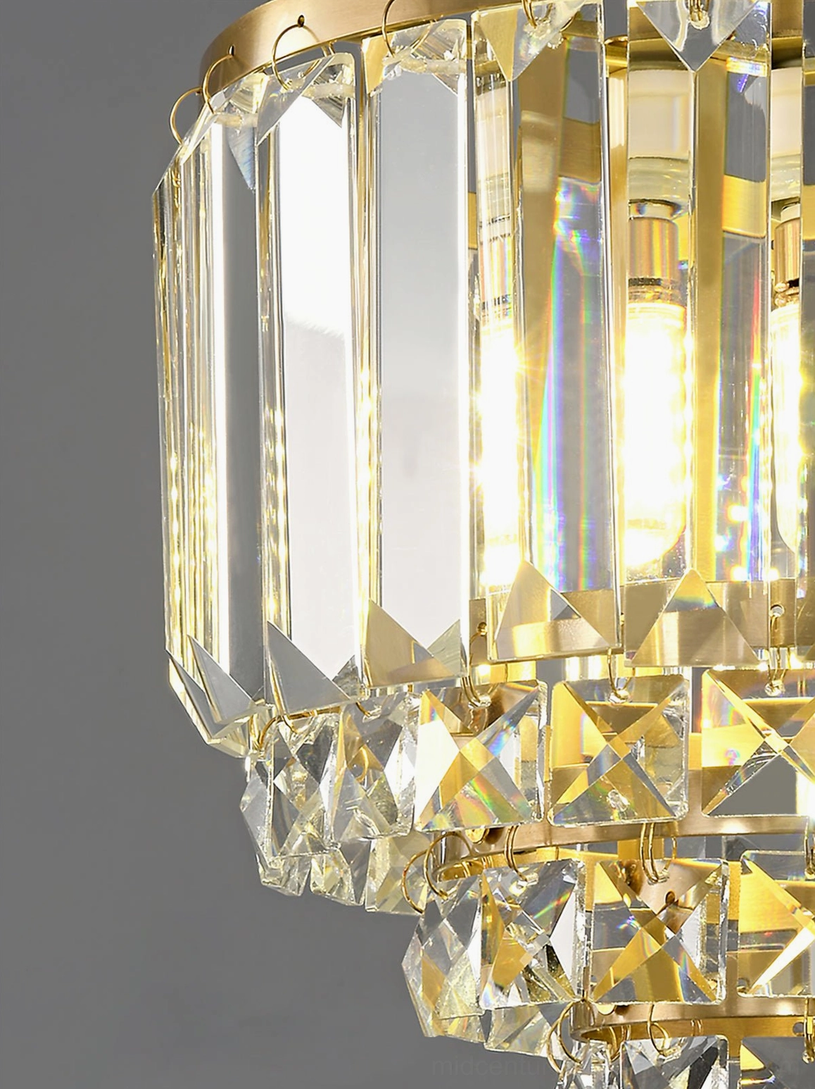 Crystal brass pendant light warm illumination glow faceted crystal tiers design detail