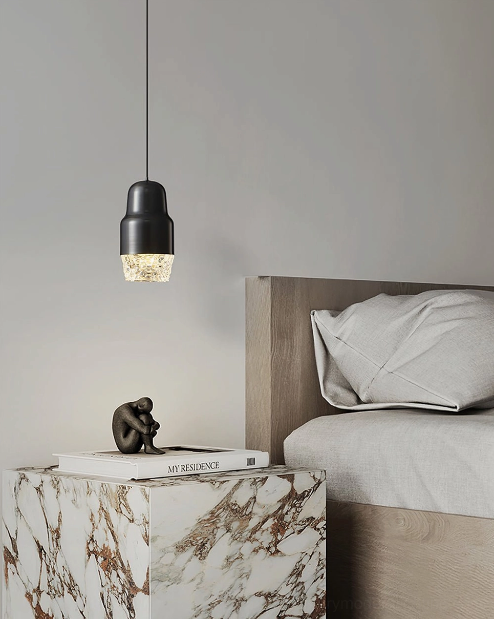 Black pendant light fixture hanging above marble nightstand in modern bedroom, accent lighting