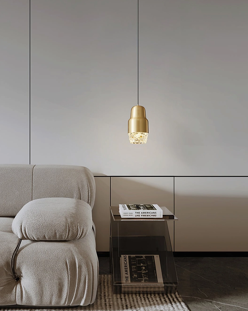 Gold Lavinia three-color LED pendant suspended above fabric sofa in minimalist living space