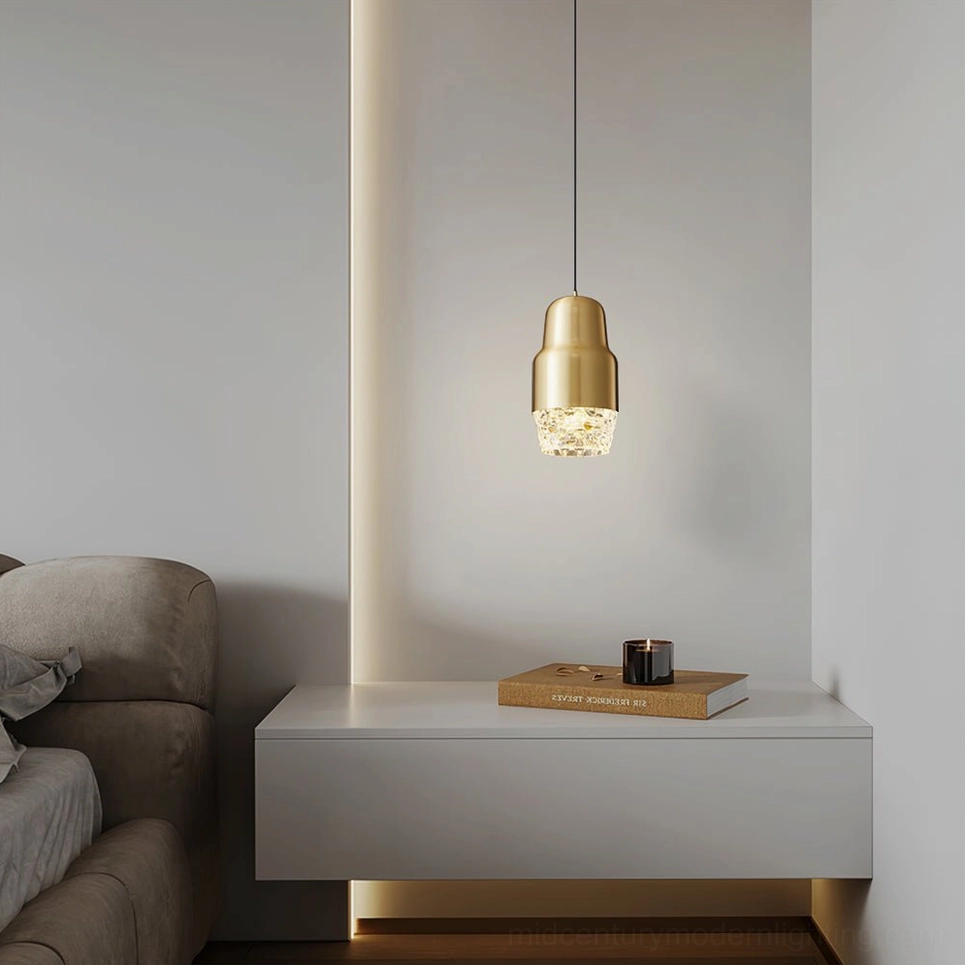 Gold brushed brass Lavinia pendant light hanging above side table in modern minimalist living room