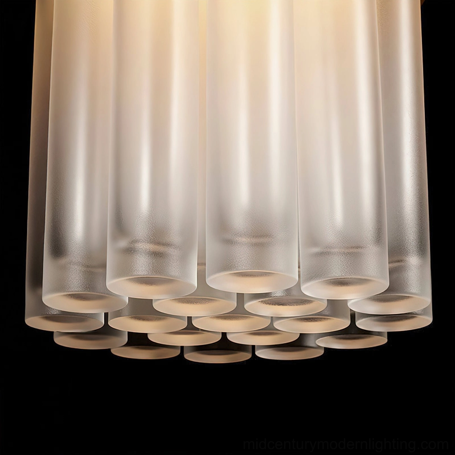 Pendant lamp shade assembly, close-up low-angle studio shot of tiered frosted ribbed glass cylinders with warm backlighting