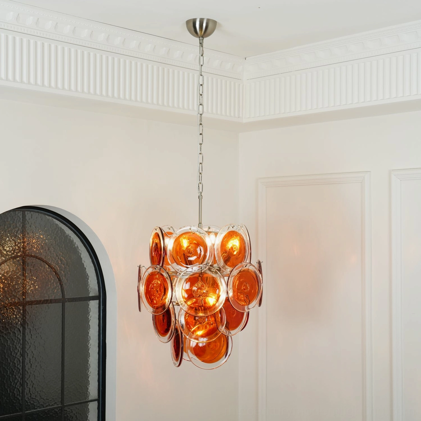 Layered Murano glass disc chandelier warm orange tones architectural lighting
