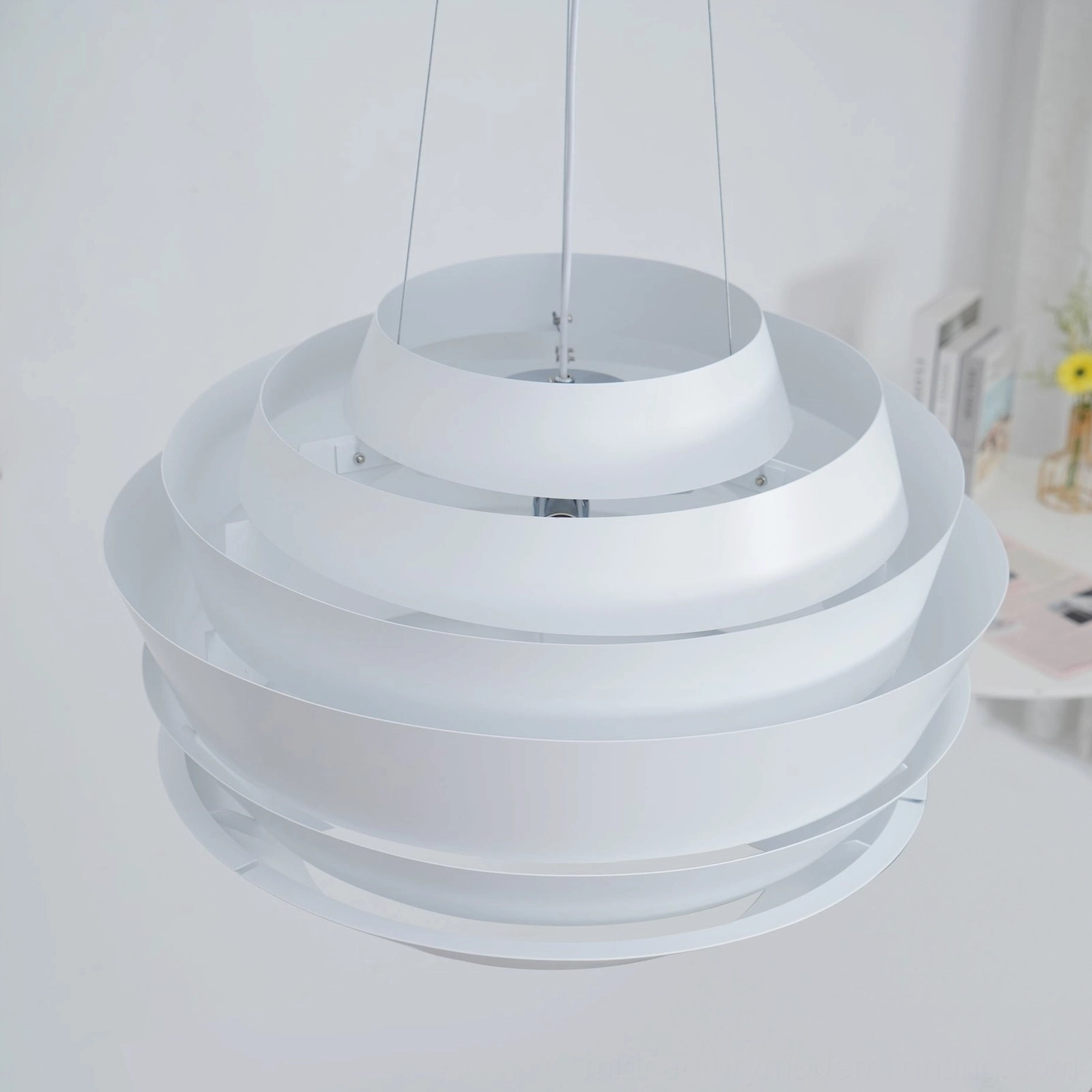 Unlit layered pendant light bottom view chrome hardware matte white tiers interior