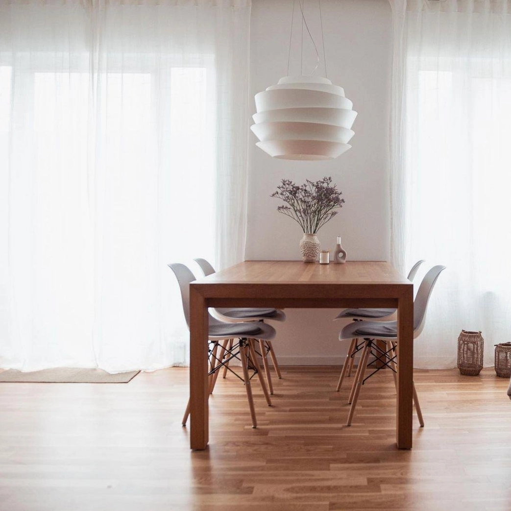 Modern tiered pendant lamp installed dining room sculptural focal point white finish