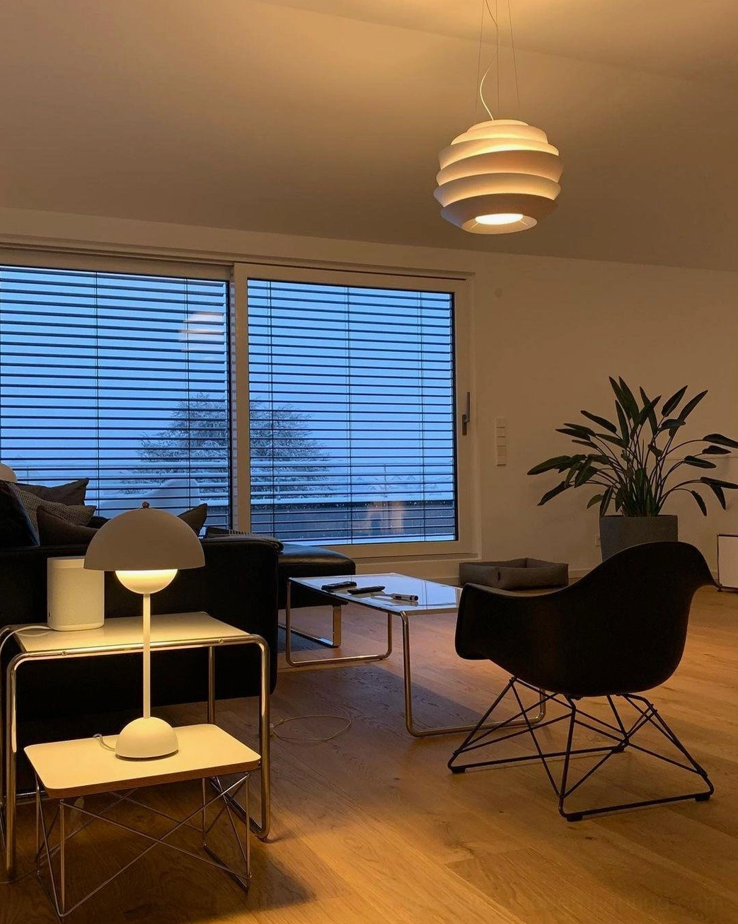 Modern pendant ceiling light above dining table conversation centerpiece warm glow