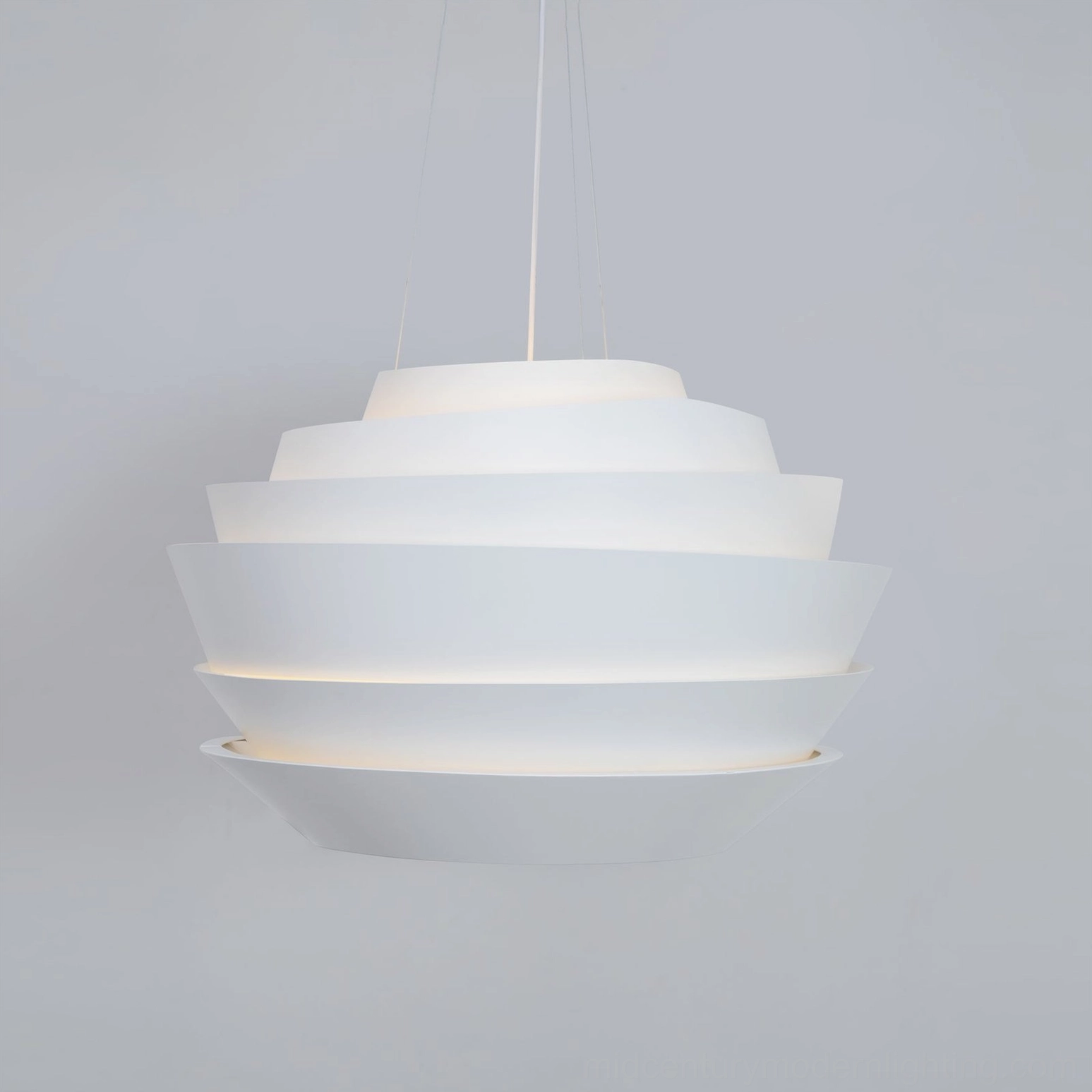 Modern layered pendant lamp side profile view sculptural geometry white finish