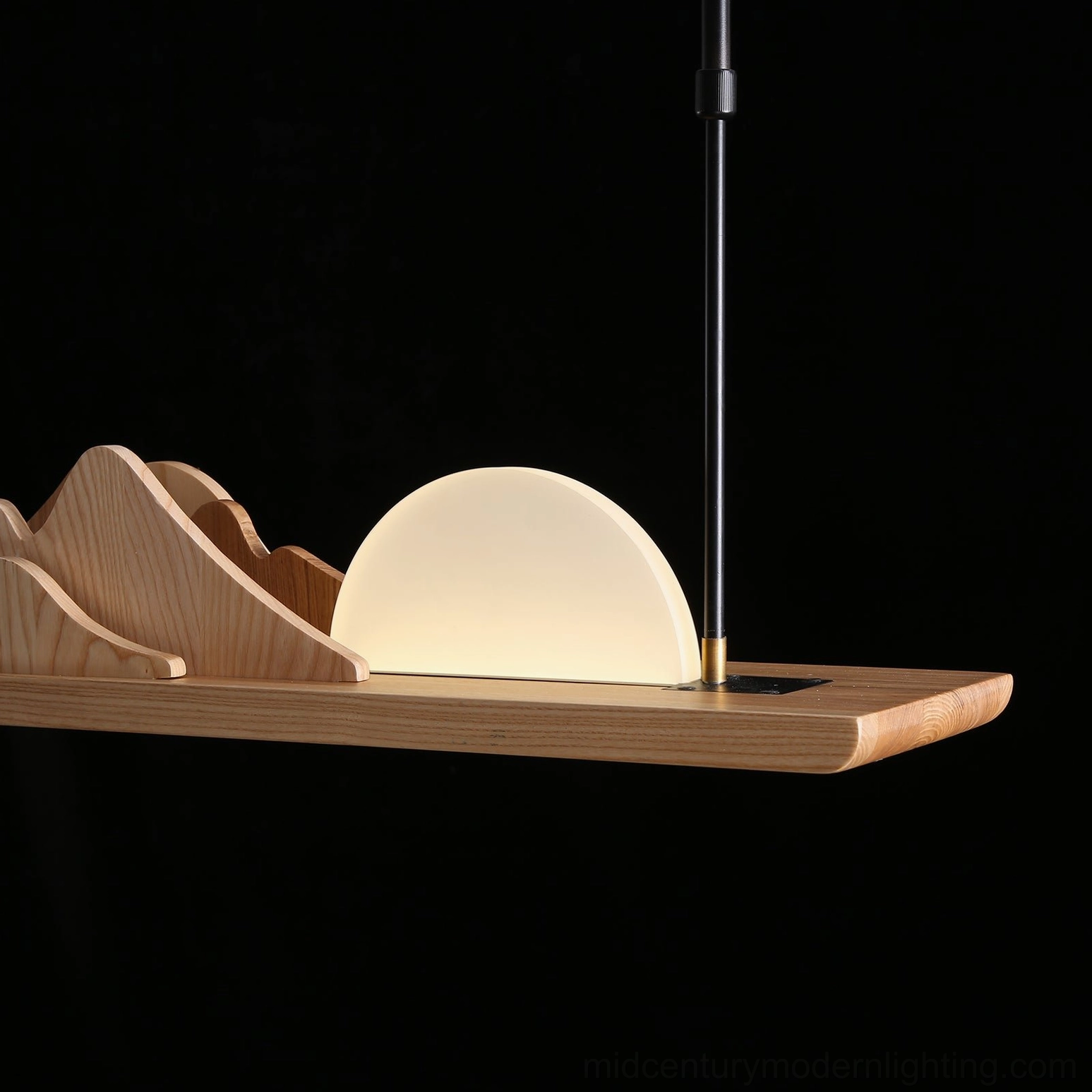 Close-up detail of Leah Mountains mountain ridge pendant – solid walnut wood base, frosted acrylic hemisphere, and black metal suspension