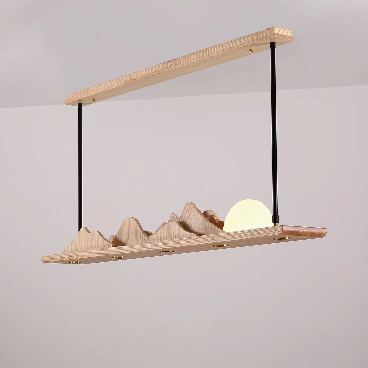 Contemporary pendant light Leah Mountains – installed in modern interior showing warm integrated LED glow over seating area