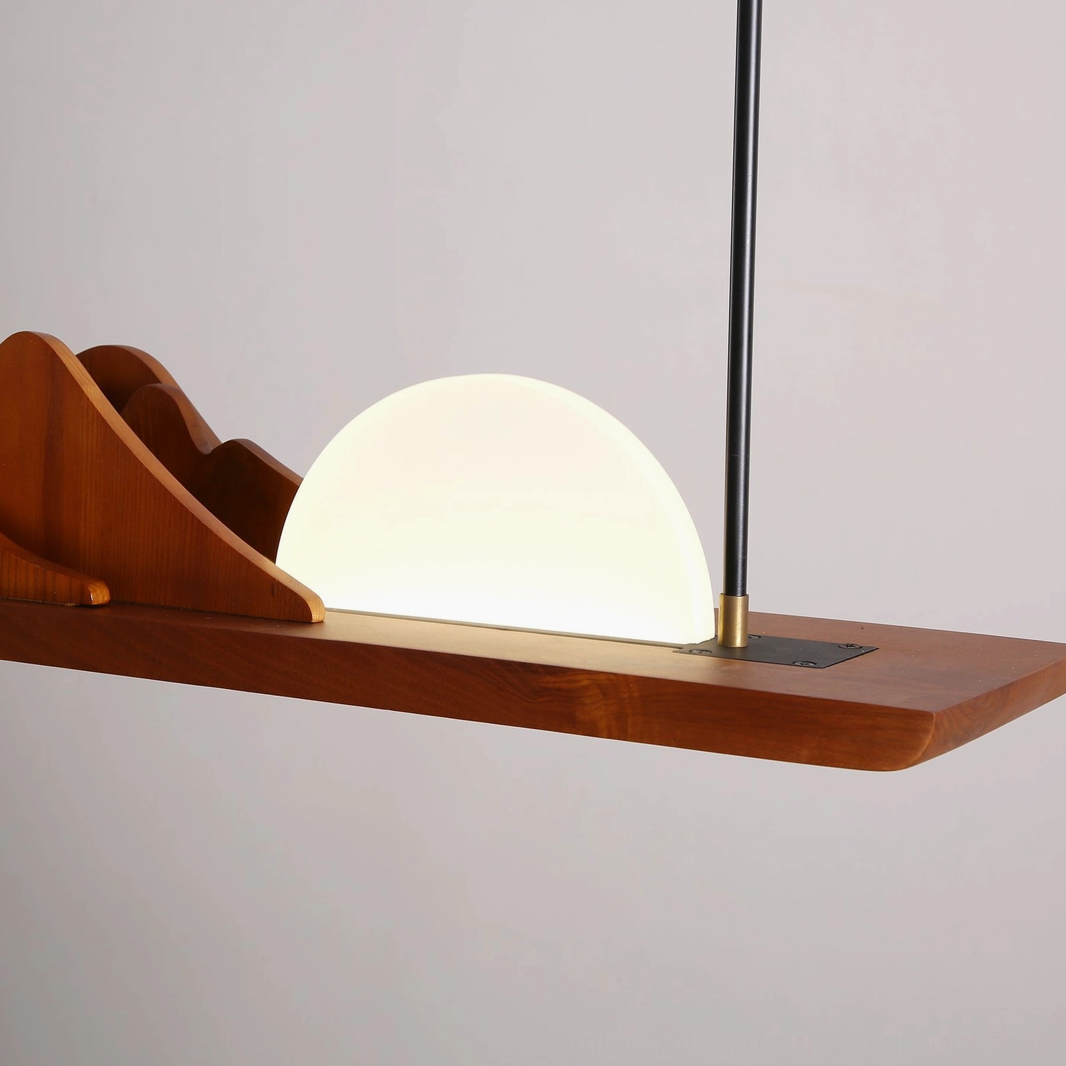 Leah Mountains 47-inch chandelier detail – warm brown wood grain mountain silhouette with brass and black metal accent