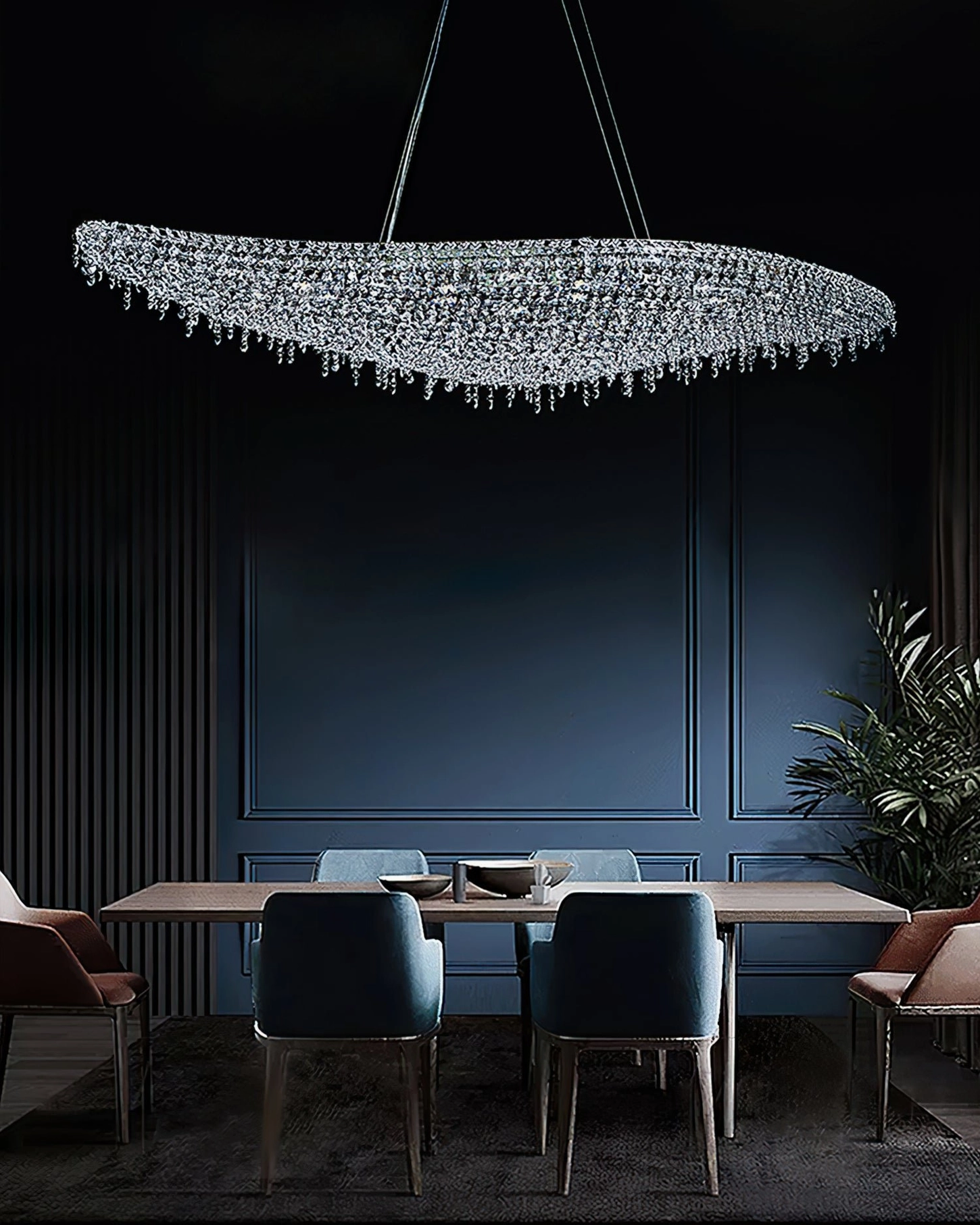 Flat oval crystal chandelier overhead view in minimalist formal dining room positioned above long dining table