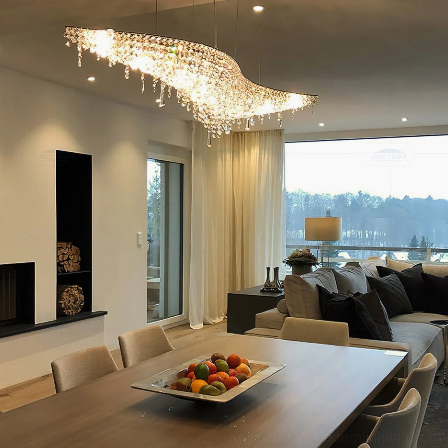 Warm-glowing leaves crystal chandelier illuminated overhead in modern open dining and living room space